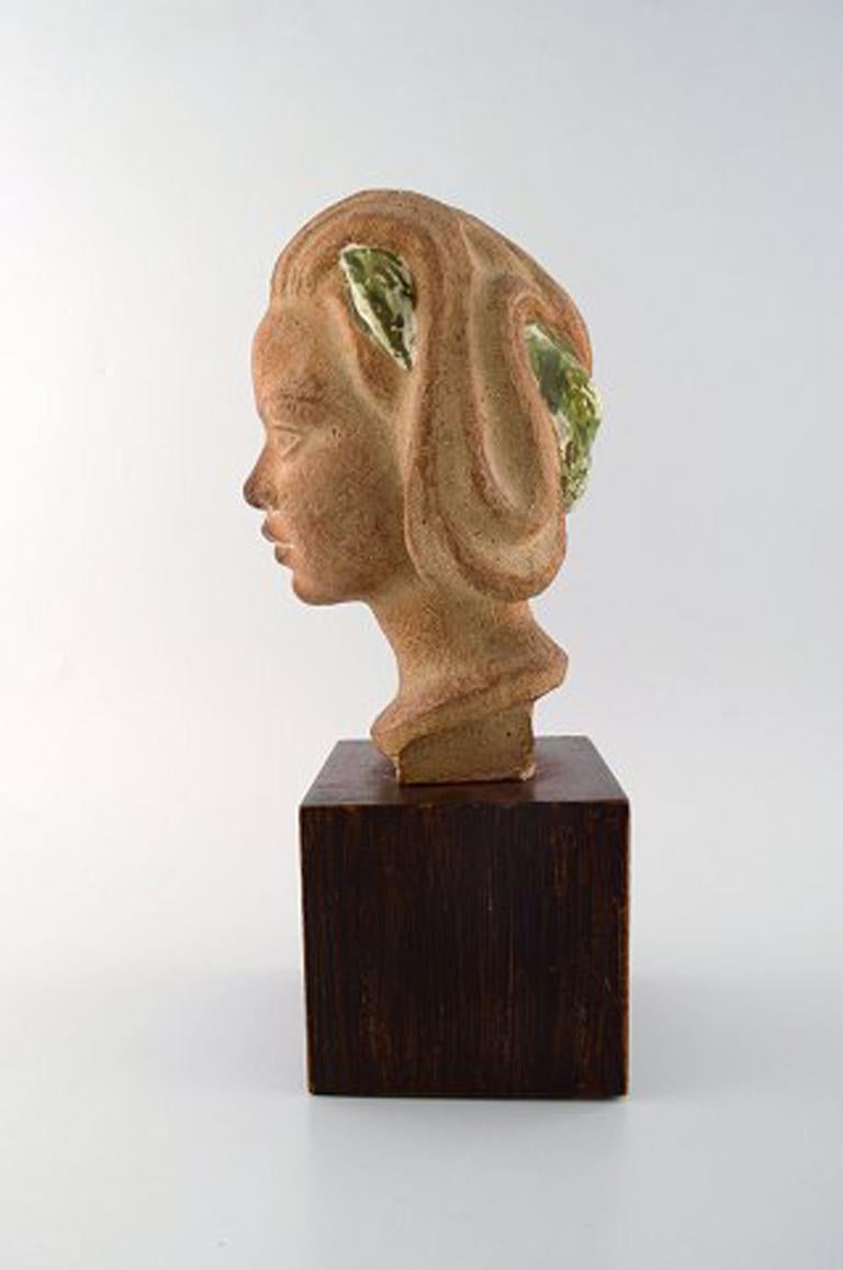 Johannes Hedegaard, own workshop. Bust of young woman in ceramics on wooden base.
Signed: Monogram JH.
Measures: 36 x 15.5 cm
In perfect condition.