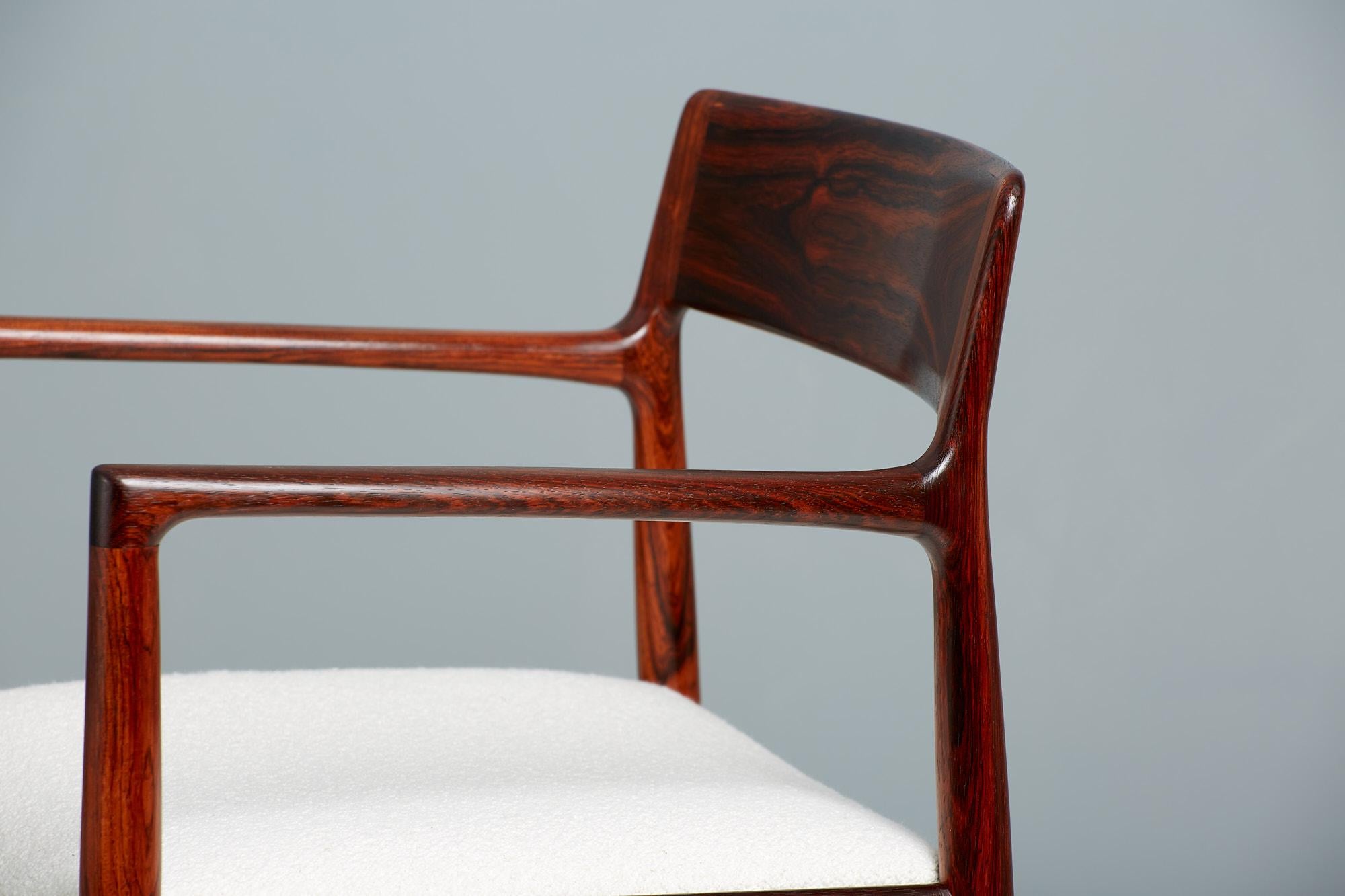 Rosewood armchair produced by Norgaard Mobelfabrik in Denmark and designed by company owner Johannes Norgaard. The frame is made from exquisitely grained solid rosewood that remains in immaculate condition. The seat is newly reupholstered in Chase