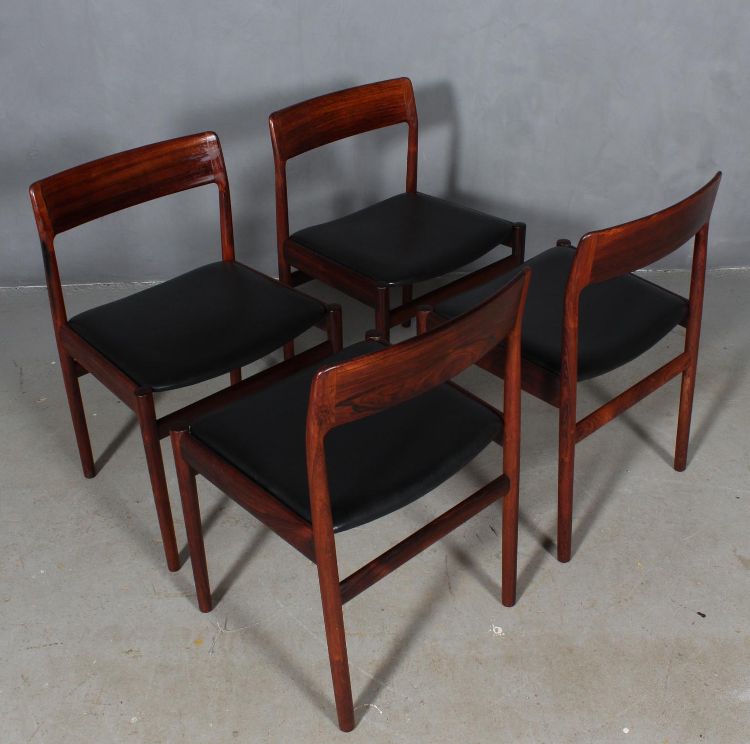 Johannes Nørgaard set of four chairs in rosewood.

Original light patinated black leather.

Made by Nørgaards møbelfabrik 1960s.