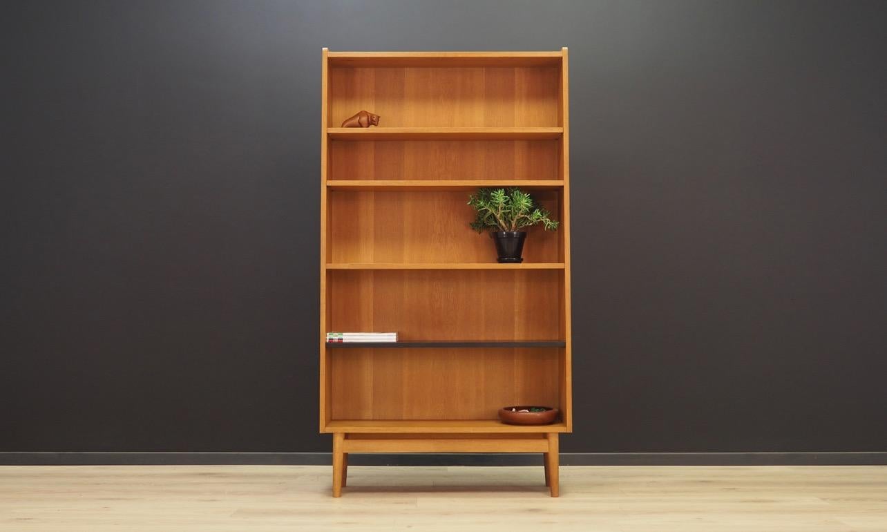 Phenomenal bookcase / library from the 1960s-1970s. Danish design, minimalistic form, attention to detail. Designed by Johannes Sorth's and manufactured by Bornholm Møbelfabrik. The surface of the furniture is covered with ash veneer. It has four
