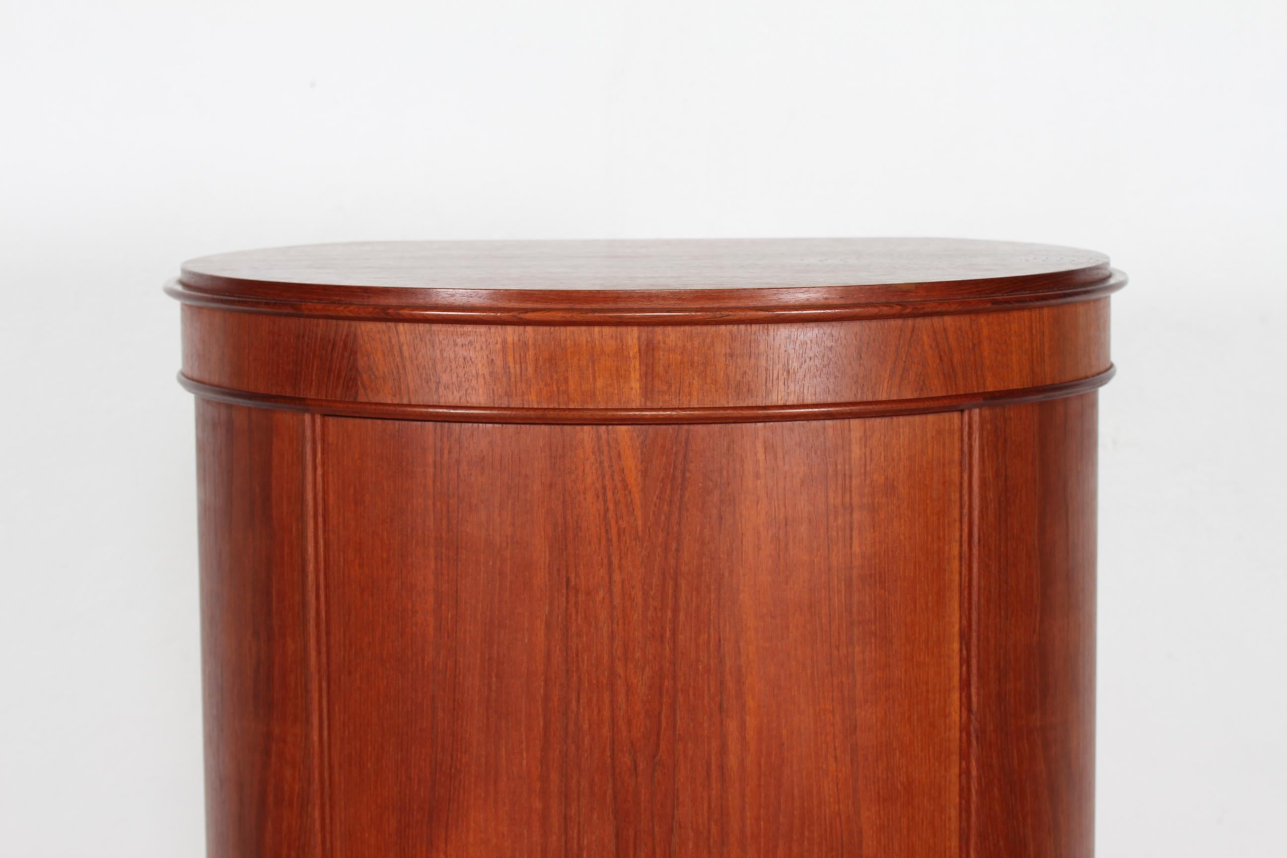 Danish modern oval pedestal cupboard with 5 shelves made of teak and teak veneer
It is designed by Danish Johannes Sorth in the 1960s

Manufacturer: Bornholms Møbelfabrik

Very nice vintage condition.
The key and lock are with full