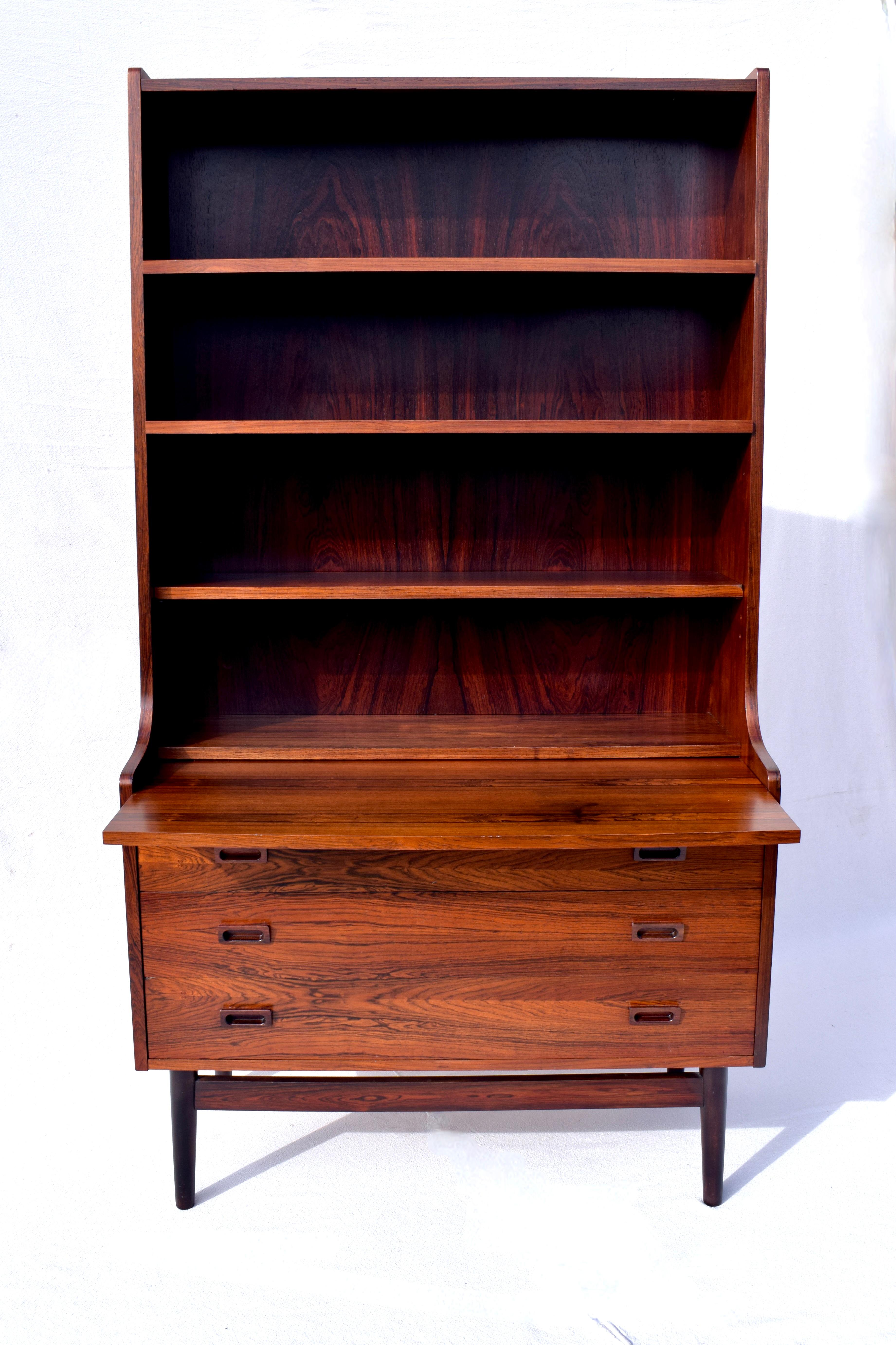 Danish Modern Brazilian Rosewood secretary desk by Johannes Sorth number 331 32. 
Multifunctional having three adjustable bookshelves to the tapered top with pull out pocket desk & three drawers. All original finish is in excellent vintage condition