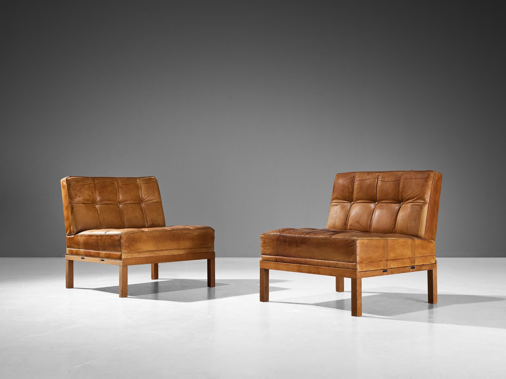 Johannes Spalt for Wittmann, lounge chairs, leather, oak, Austria, 1960s 

This beautiful pair of lounge chairs is designed by architect Johannes Spalt, is typical for mid-century modern design from Austria of the 1960s. The tufted cognac leather