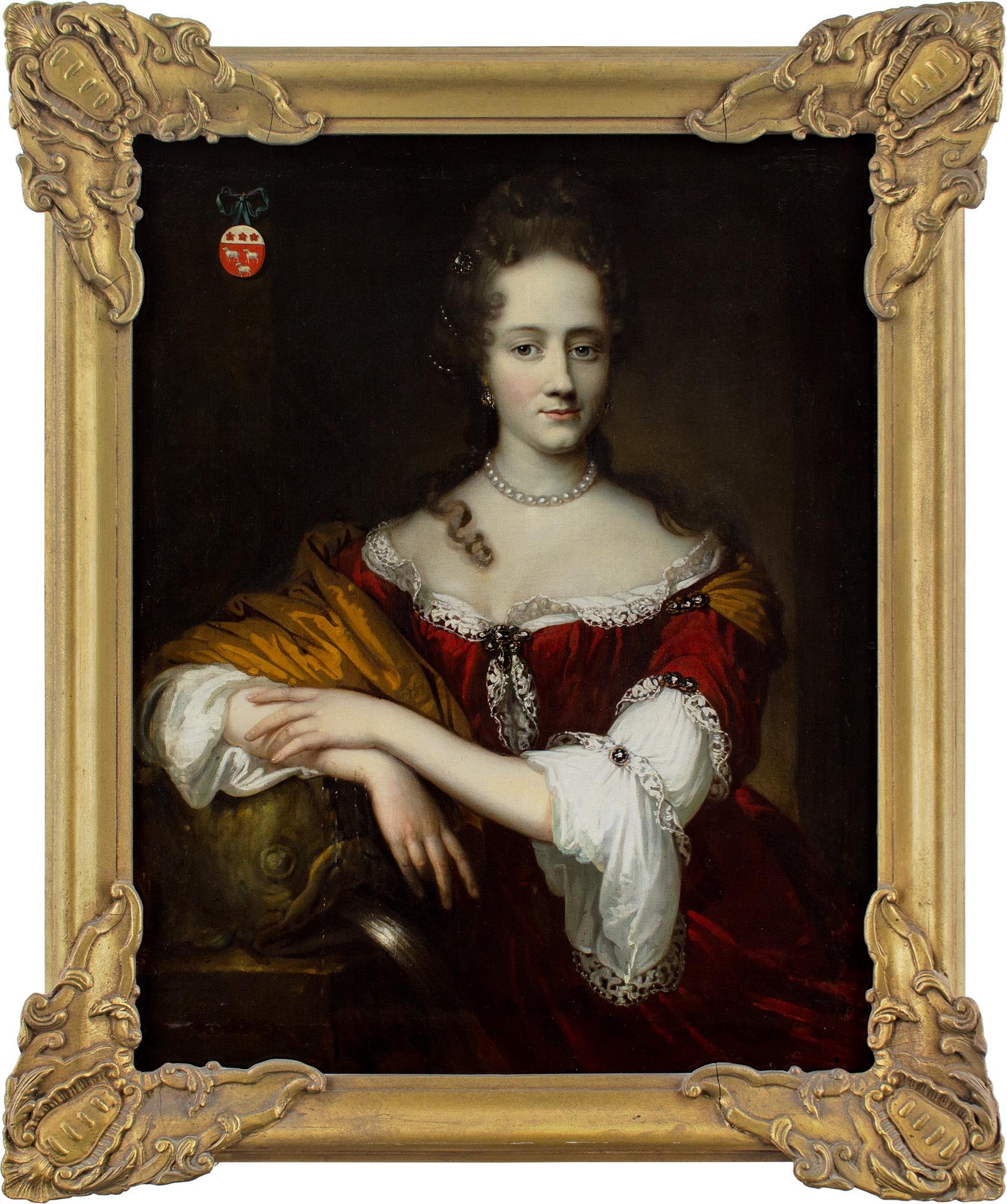 This splendid late 17th-century three-quarter-length portrait by Dutch artist Johannes Vollevens I (1649-1728) depicts a lady wearing a plush red gown with a low, lace-trimmed neckline, together with a pearl necklace. The coat of arms in the upper