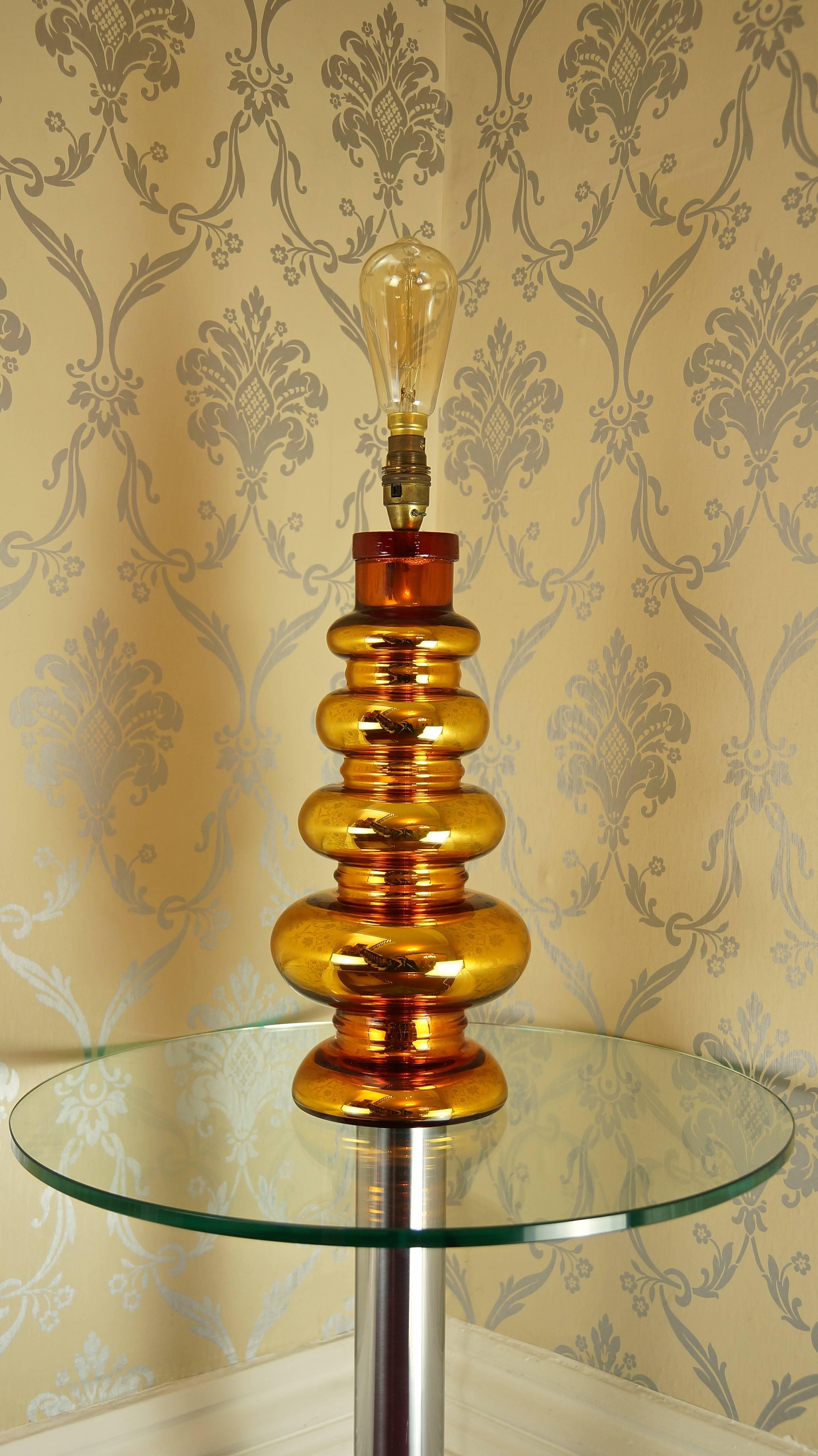A beautifully crafted gold coloured mercury glass table lamp, with signature textured glass cap by Johansfors Glasbruk of Sweden dating from the 1960s.

The glamorous gold colour and incredible form of this lamp make it a very eye-catching piece