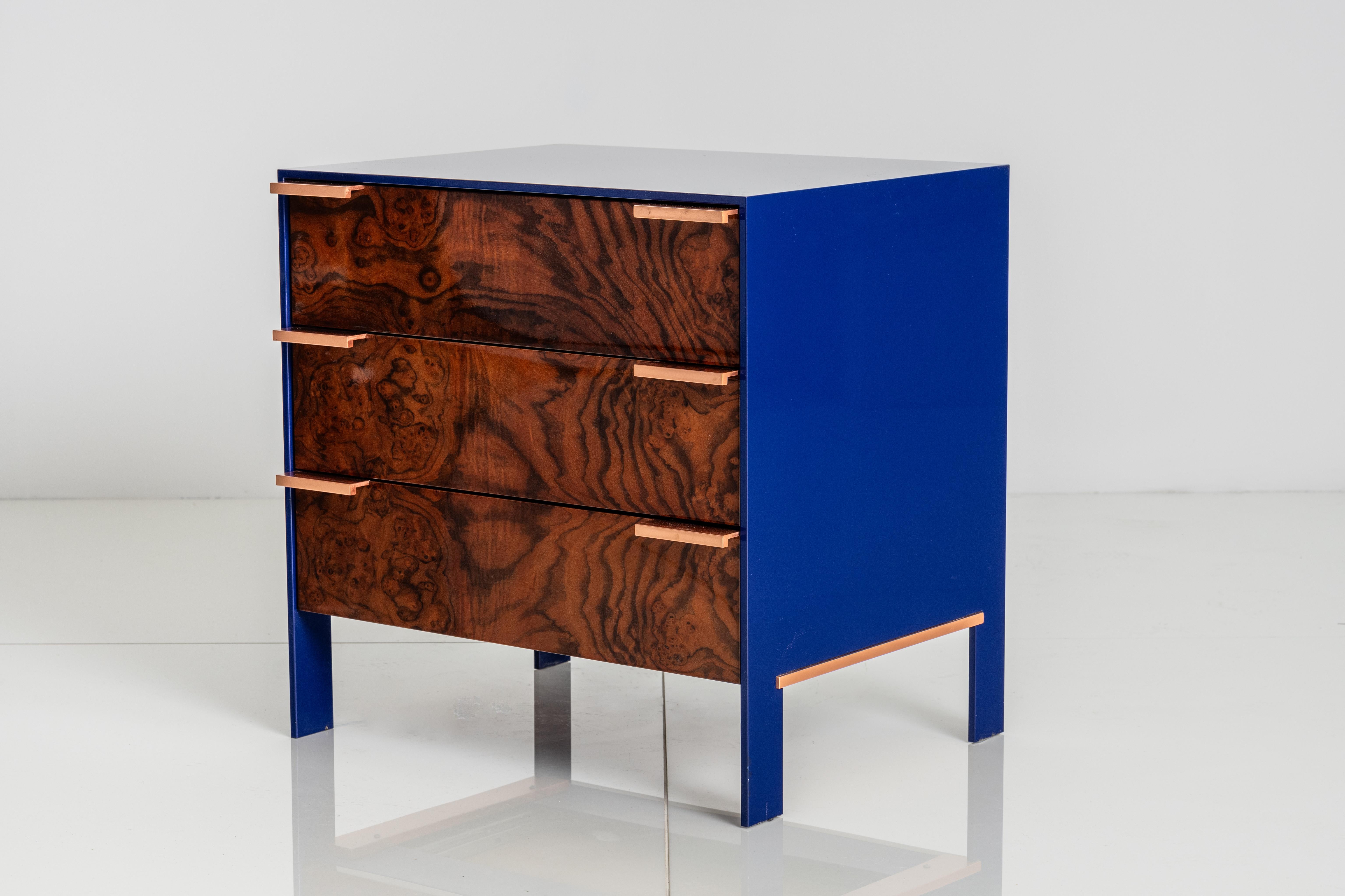 Lacquered aluminum skin encases the cabinet constructed of wood veneer exteriors & solid wood interiors and finished on all sides.  Drawers have solid metal pulls.