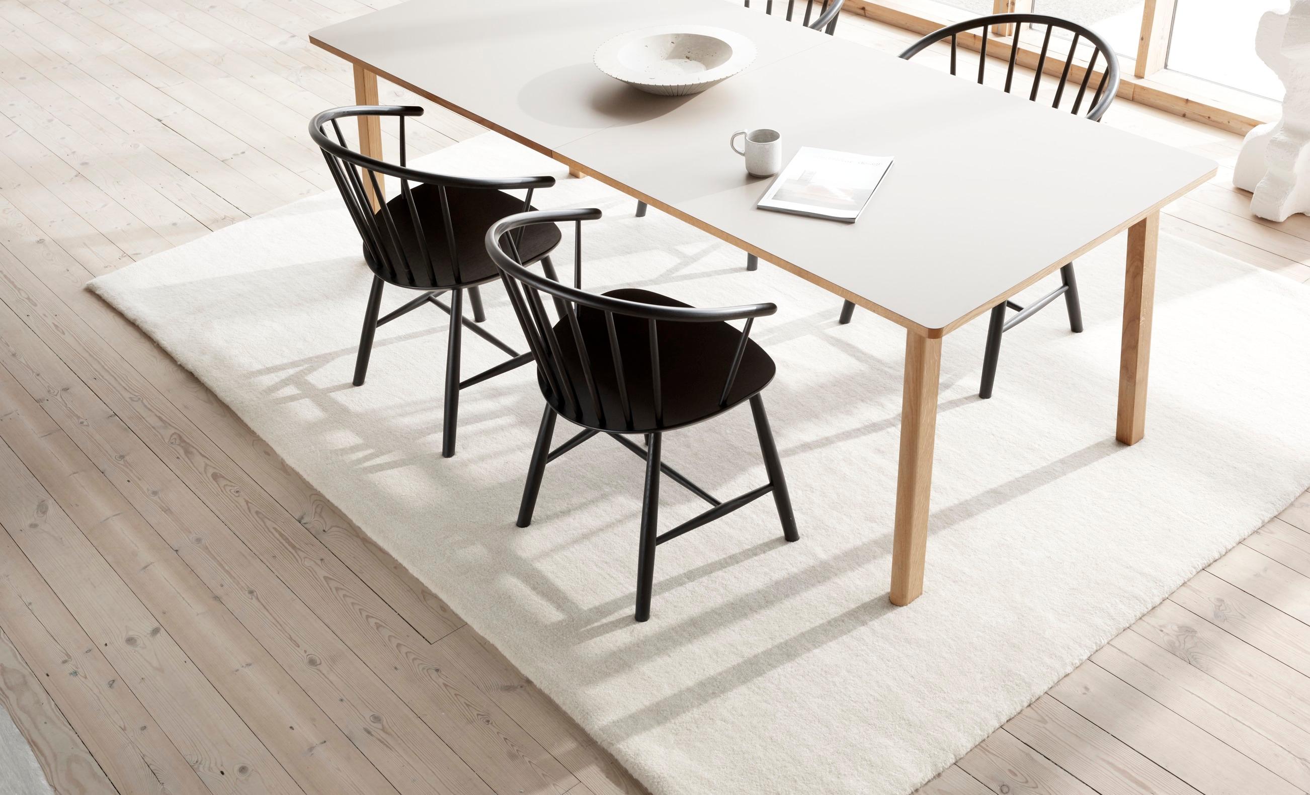 The embracing spindle back and gentle, sloping armrests make the J64 chair a classic, yet visually graphic design. 
The curve of the seat and back add ergonomic comfort and allows for many seating postures. The J64 is ideal as a dining chair or as a