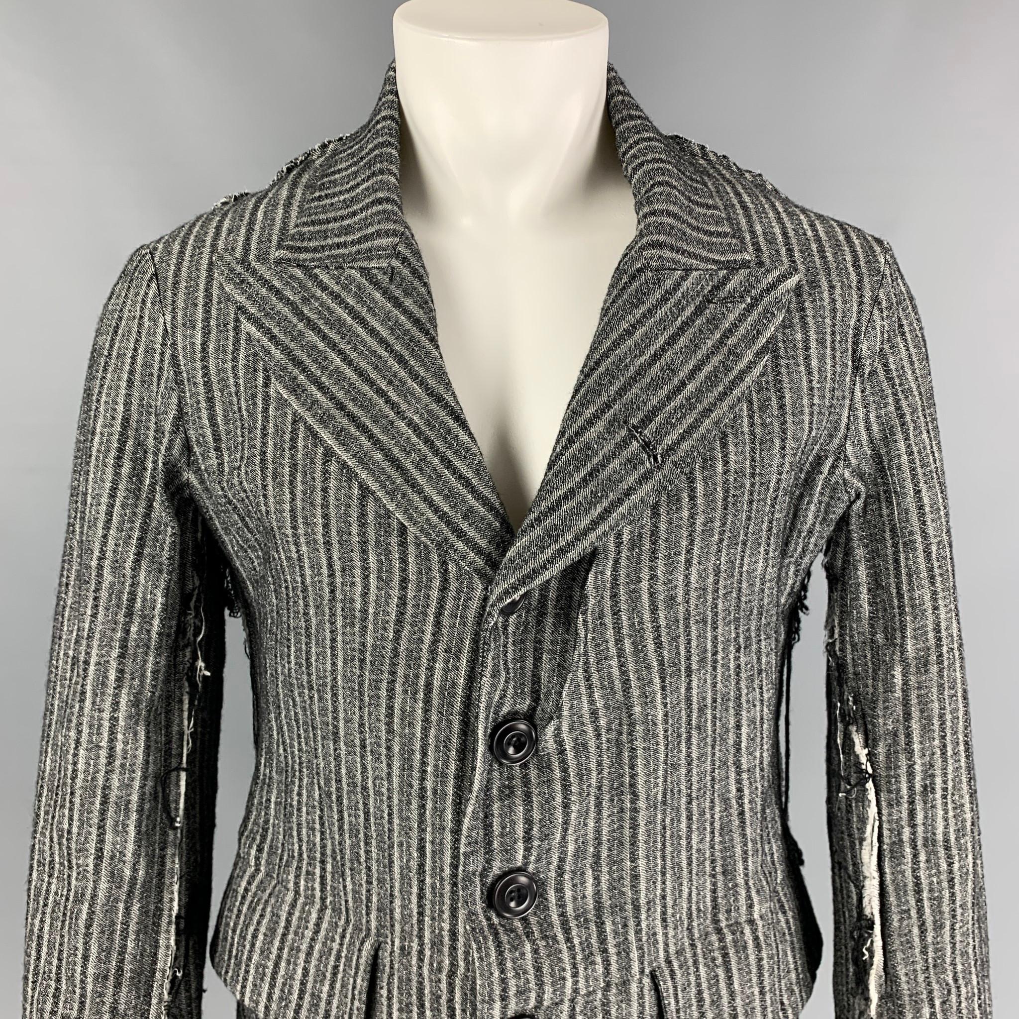 JOHN ALEXANDER SKELTON from L'ECLAIREUR sport coat comes in a grey stripe material featuring a peak lapel, ribbed seams, distressed, flap pockets, and a buttoned closure. Made in England. 

Very Good Pre-Owned Condition.
Marked: