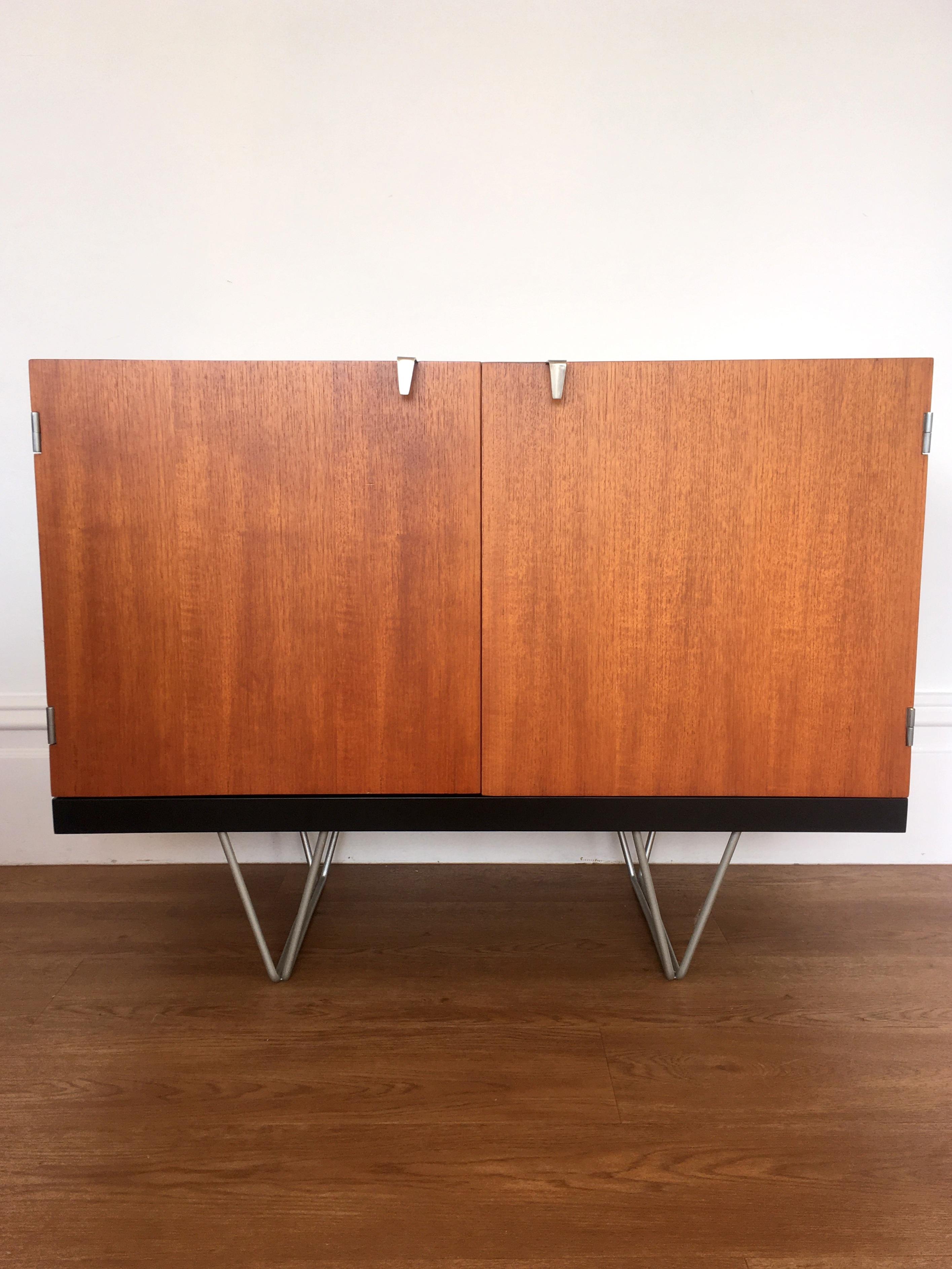 Model S203 sideboard designed by John and Sylvia Reid in the 1960s for Stag, UK

The sideboard features external teak veneers with a contrasting beech interior on brushed satin nickel v shaped legs.

The sideboard has been professionally