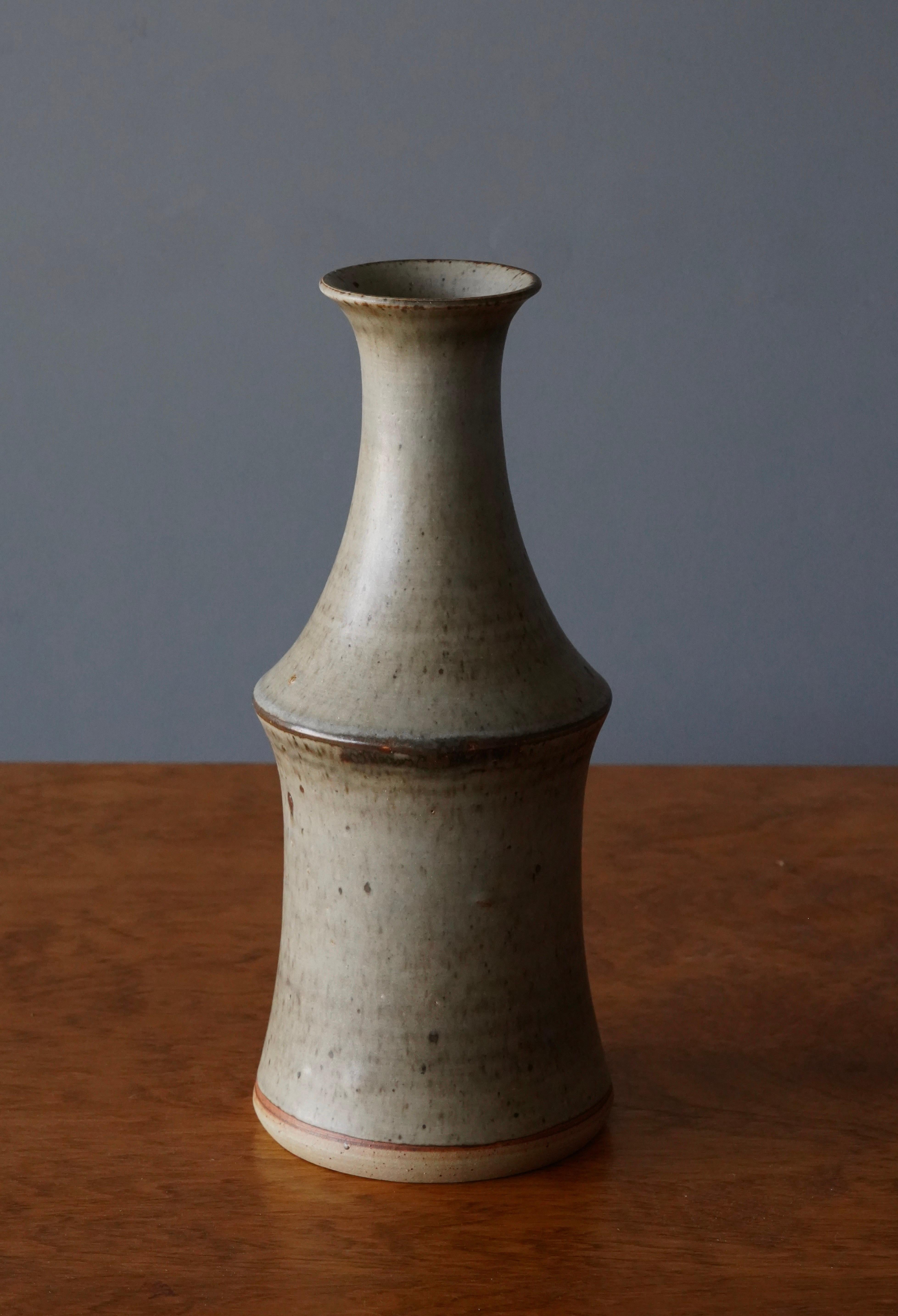 A vase, designed by John Andersson, for Höganäs Keramik, Sweden, c. 1950s-1960s. 

Features glazed stoneware. Artistic glaze in grey with tones of brown and green.