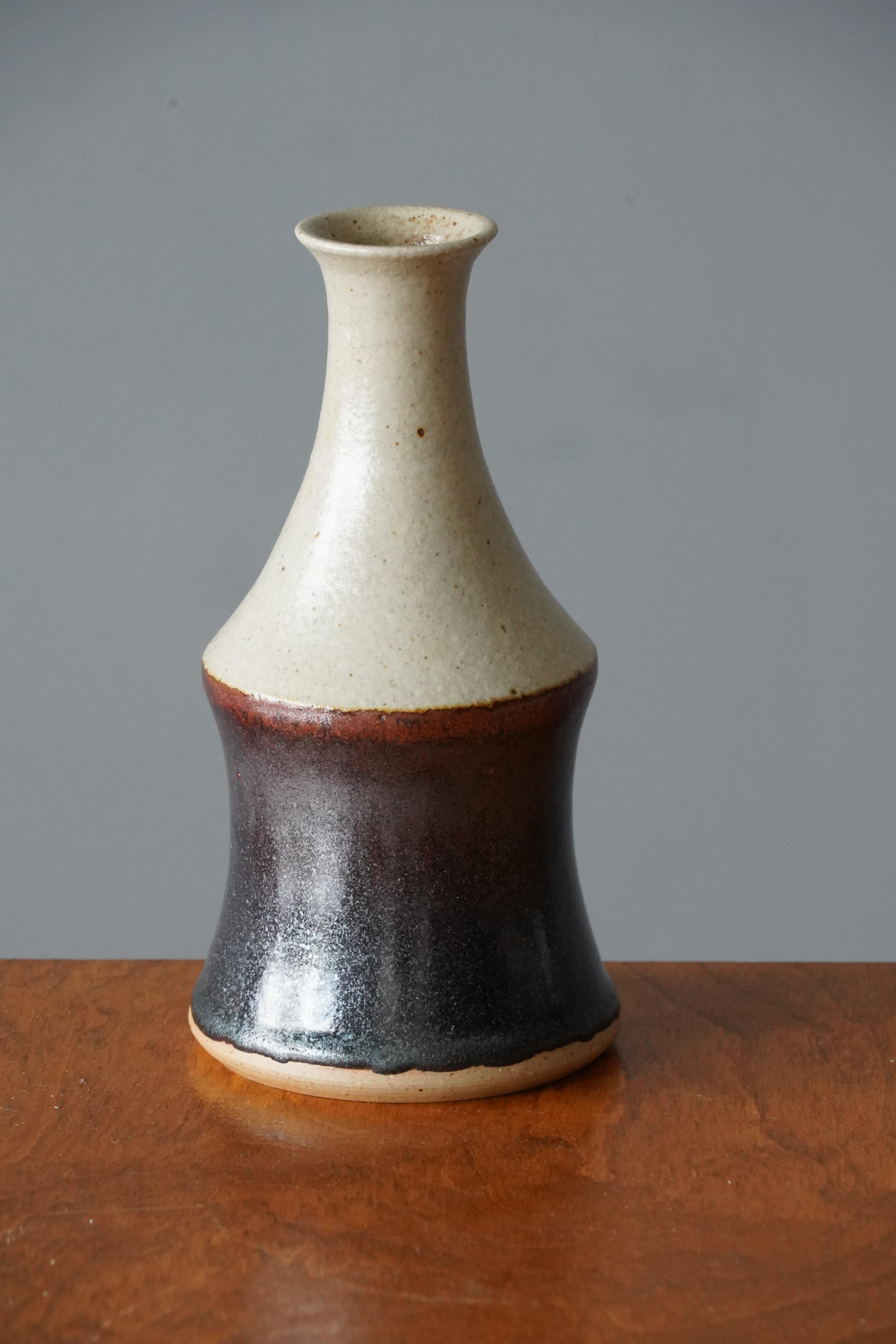 A vase, designed by John Andersson, for Höganäs Keramik, Sweden, c. 1950s-1960s. 

Features glazed stoneware. Artistic glaze in grey with tones of brown and grey.