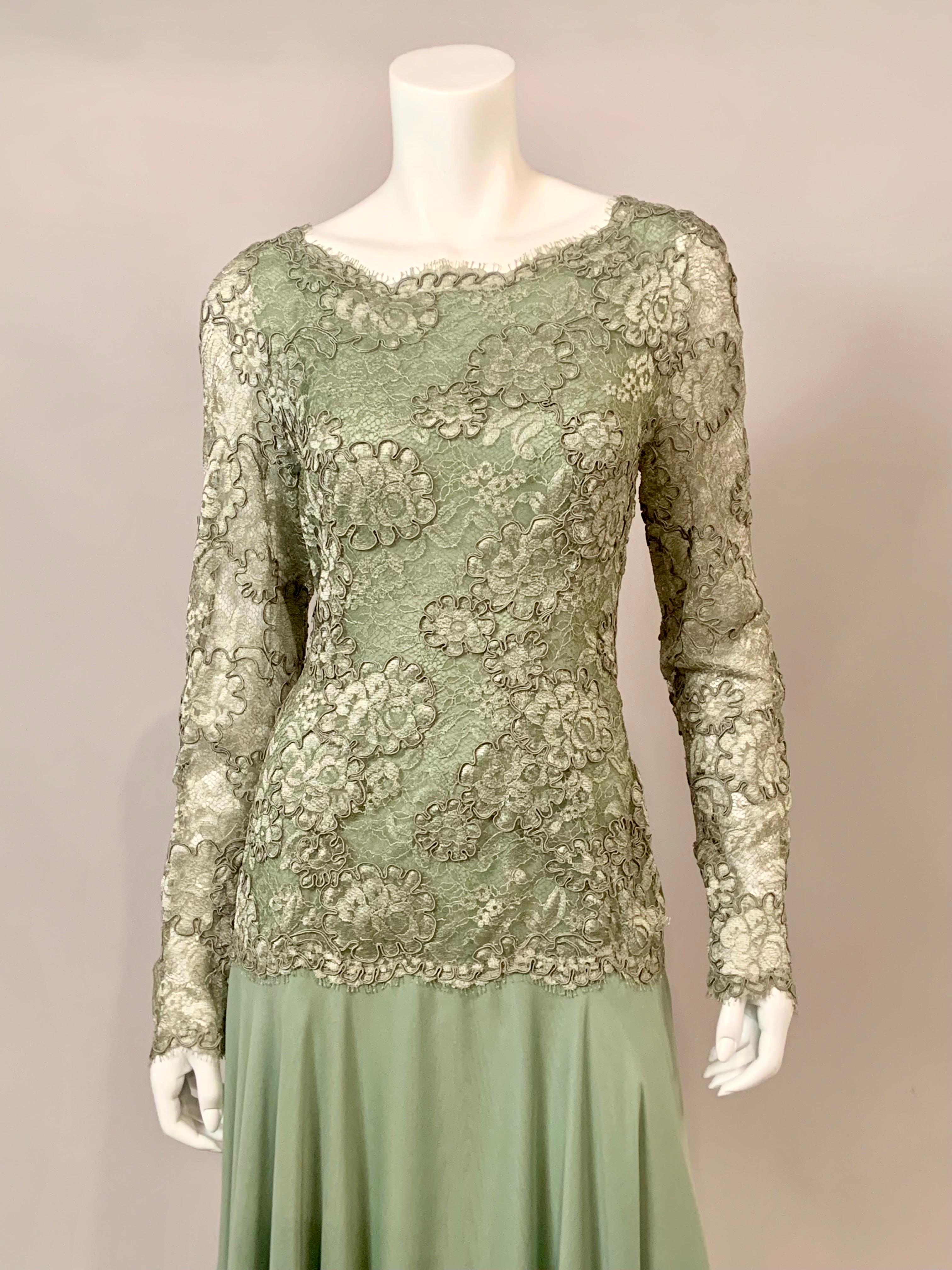 John Anthony has designed an elegant and feminine evening dress combining  a hip length pale green lace bodice with a matching green skirt made from four layers of silk chiffon.  The dress has fabric covered snaps at the wrists and a center back