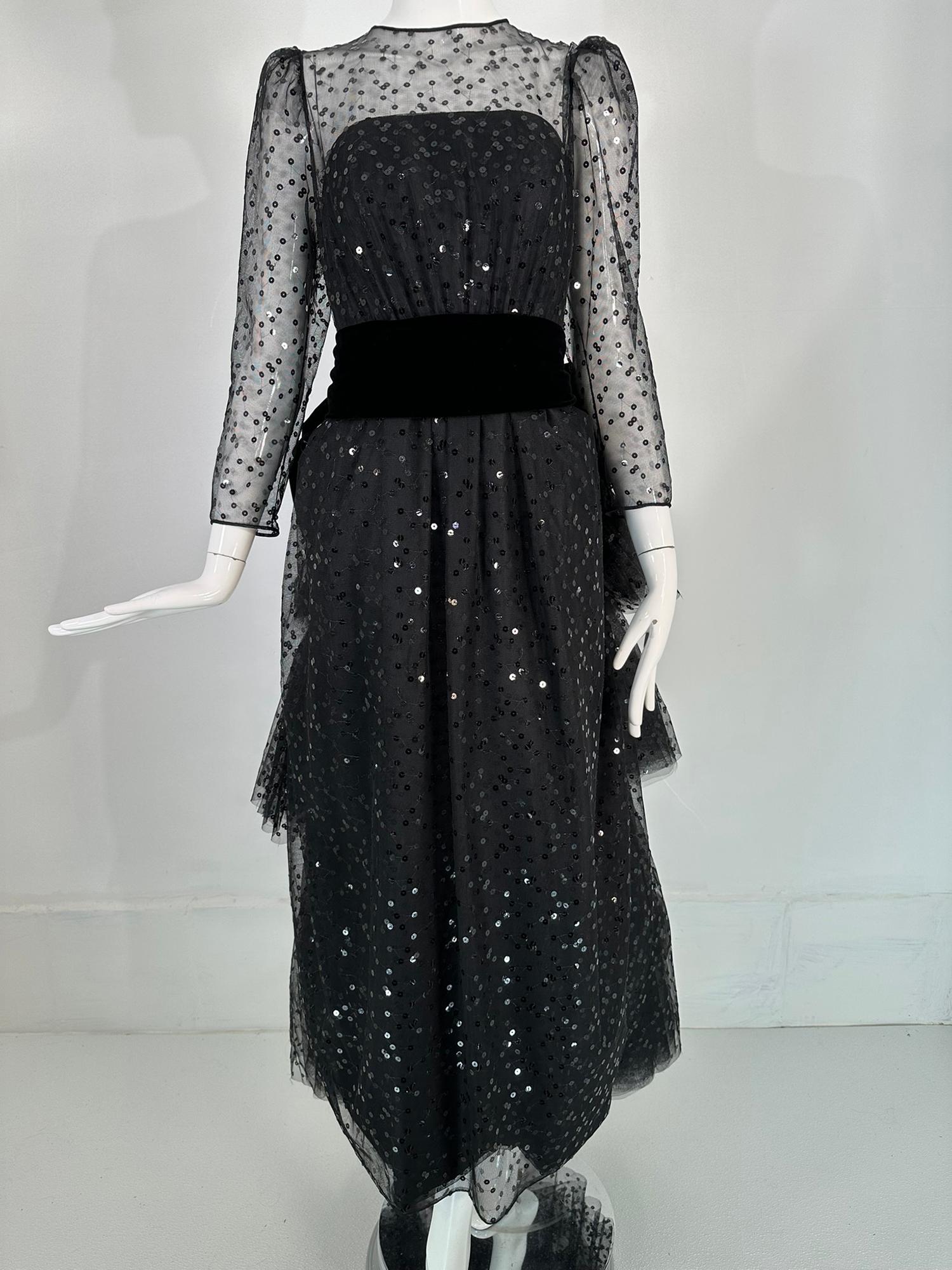 John Anthony sequined black tulle, black rose bustle back evening gown from the 1980s. Corset bodice fully boned and lined inside, the outer bodice is a sequined sheer back tulle, jewel neckline, long sleeve attached top, it closes at the back with