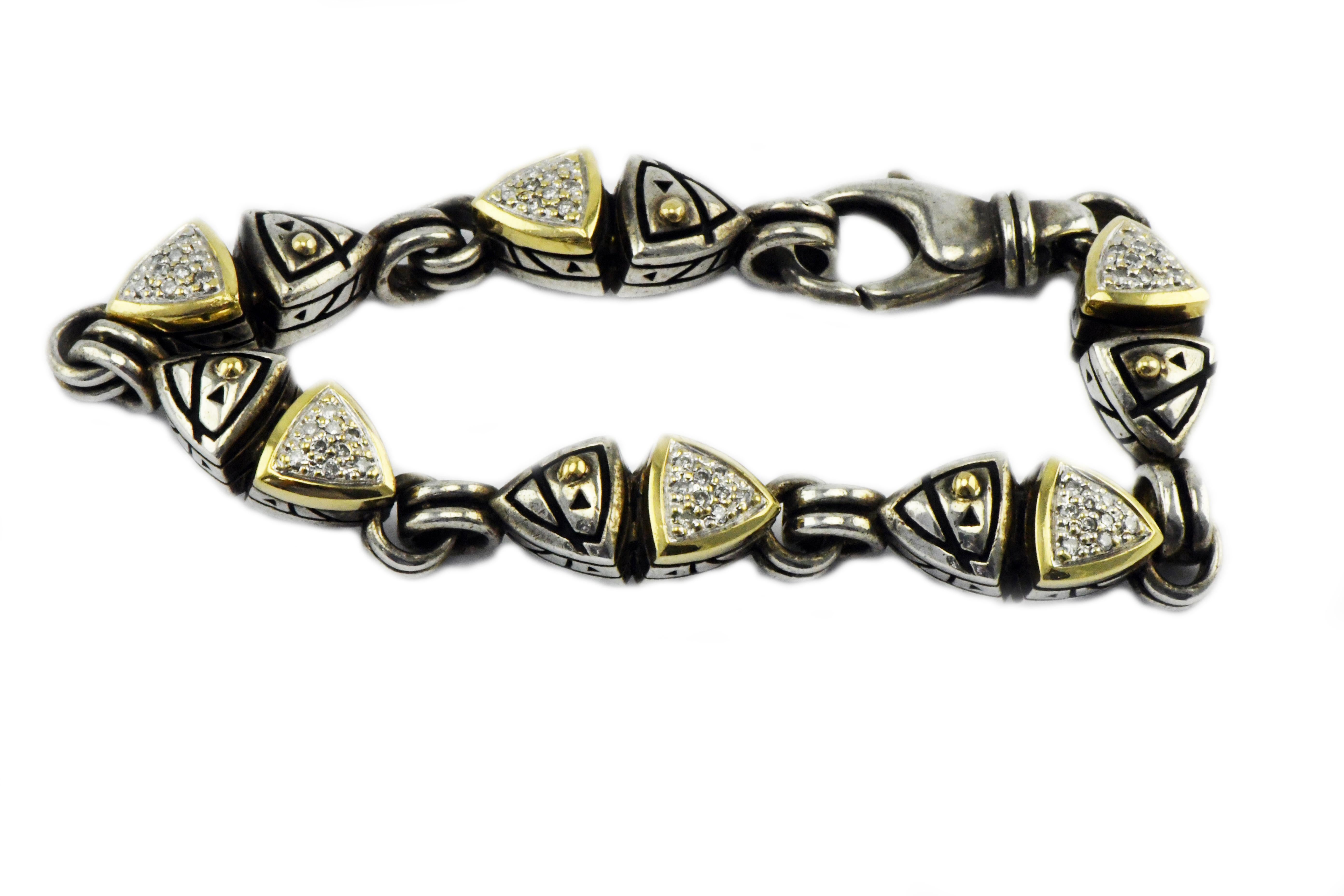 John Atencio 18k Gold and Sterling Silver Bi-Metal Bracelet 7 ½” With 2.7ctw Pave Diamonds 43.2 grams. Beautiful and Heavy.  John Atencio has designed fine jewelry in Colorado for more than 40 years.
His first inspired attempt at making jewelry was