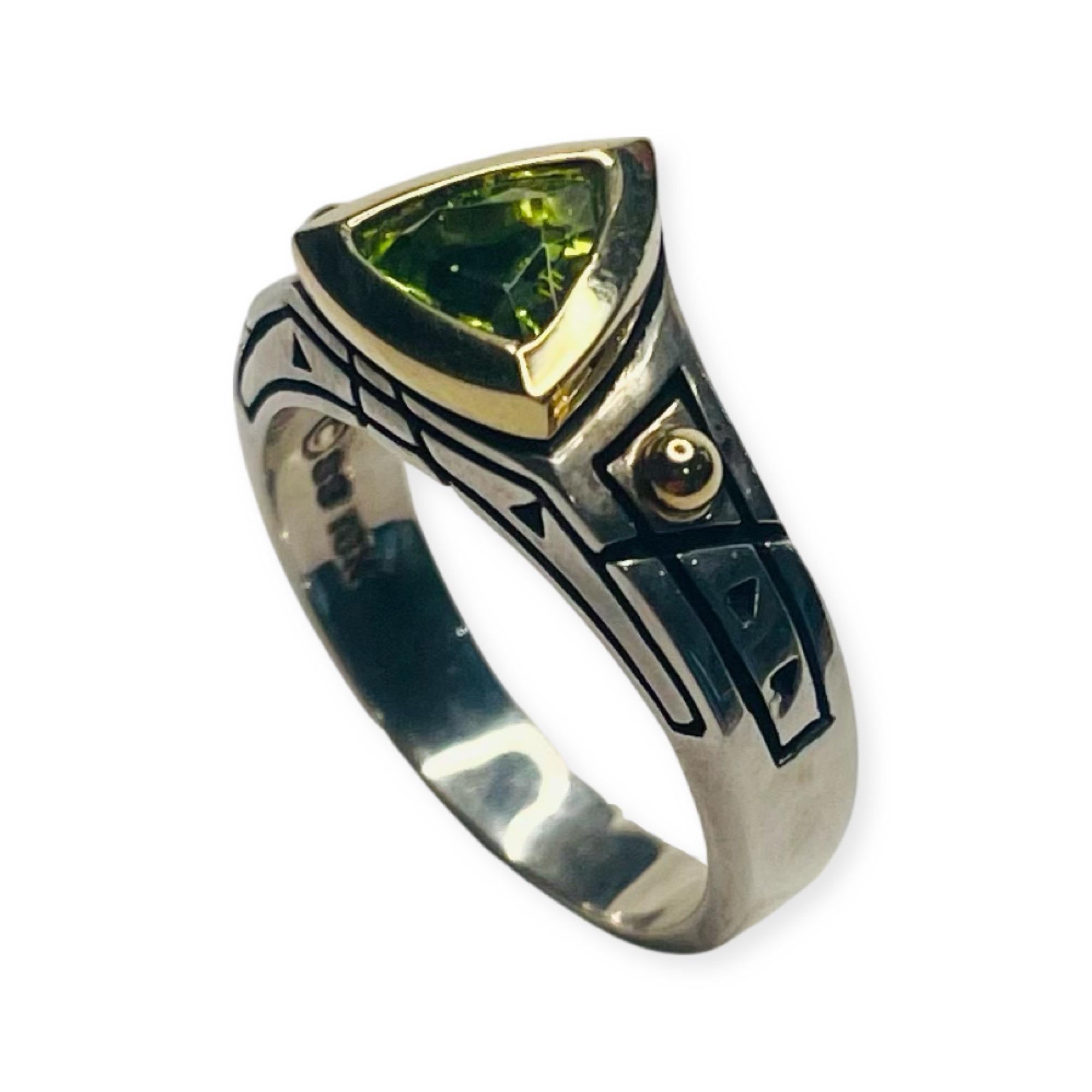 John Atencio 18KY gold and Sterling Silver RIng . The Hallmarks are 18K and 925. The trademark is JA. The peridot is 9.5 mm and is set in an 18K yellow gold bezel. The shank is measures 6.6 mm at the top and tapers to 3.8 mm at the base.  This ring