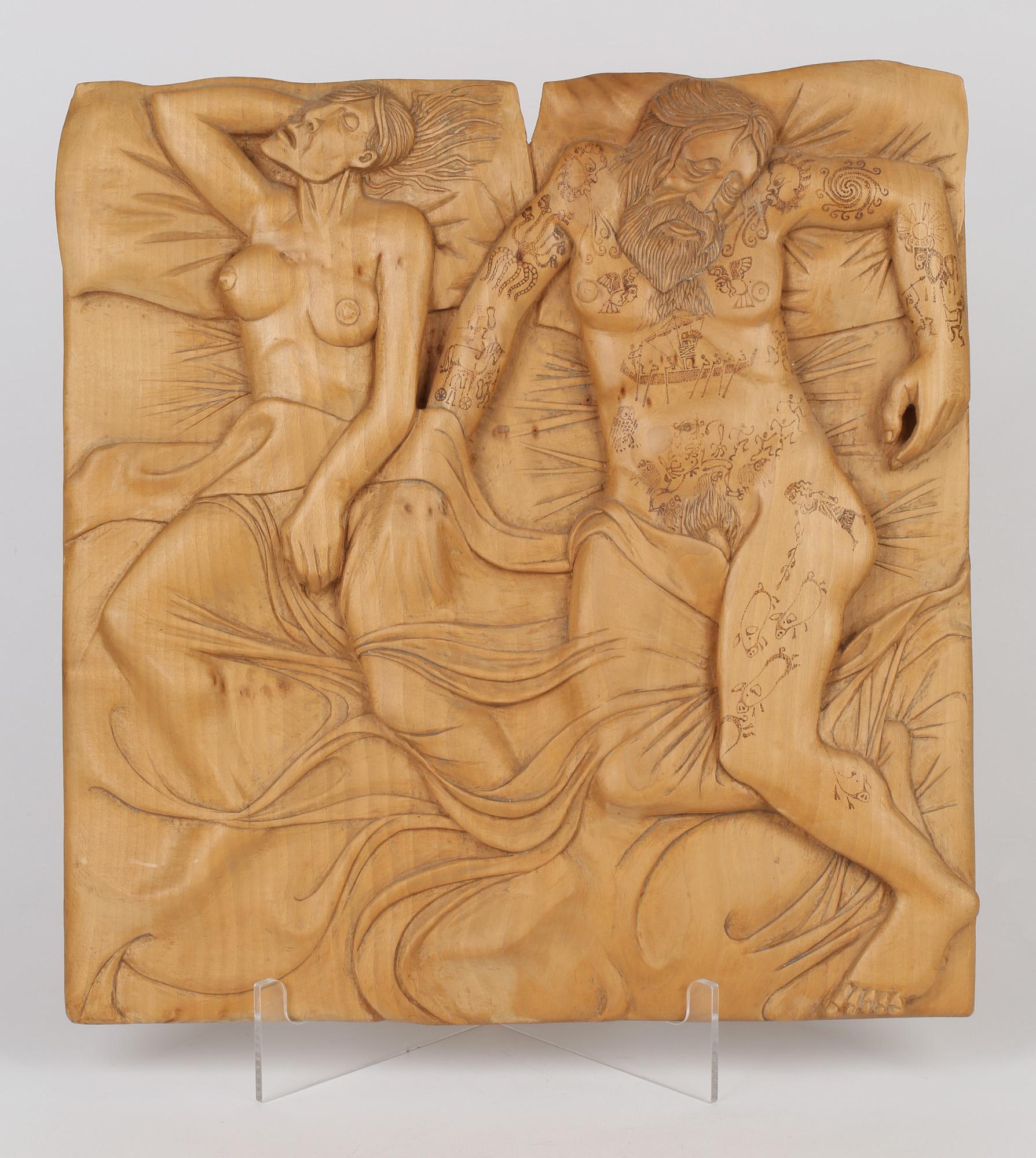 A rare, unique and very unusual sculptural hand carved wooden plaque depicting a nude couple in bed signed John Baldwin (b. London, 1937) and dated 1985. The rectangular shaped plaque is carved in deep relief and depicts a bearded man sleeping