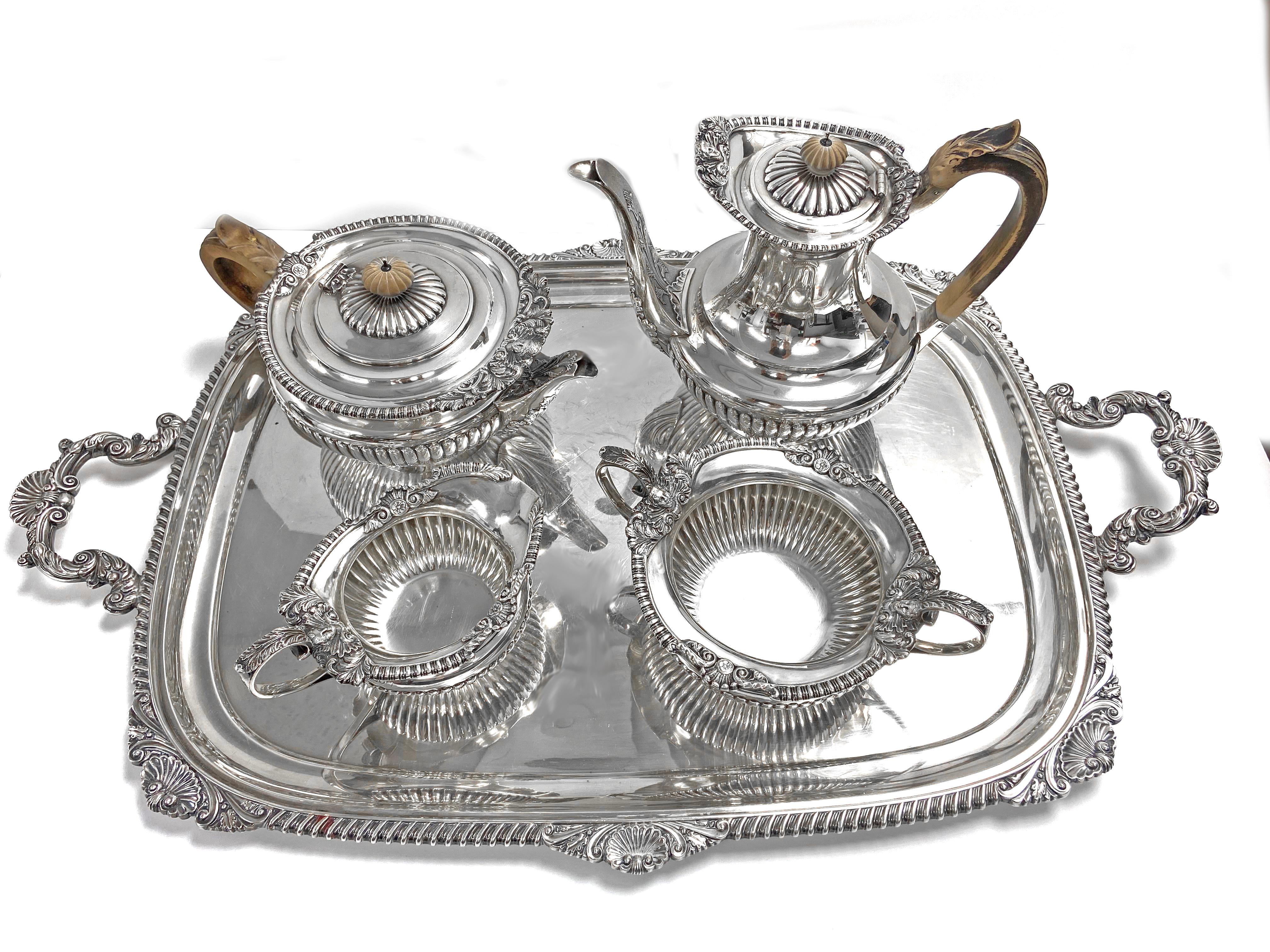 From William & John Barnard & Sons with Robert Dubock a tea service with tray. The tea service is designed in the late Regency style with half reeded baluster form with gadrooned.  The tray features a shell and gadrooned boarder and handle.  Note
