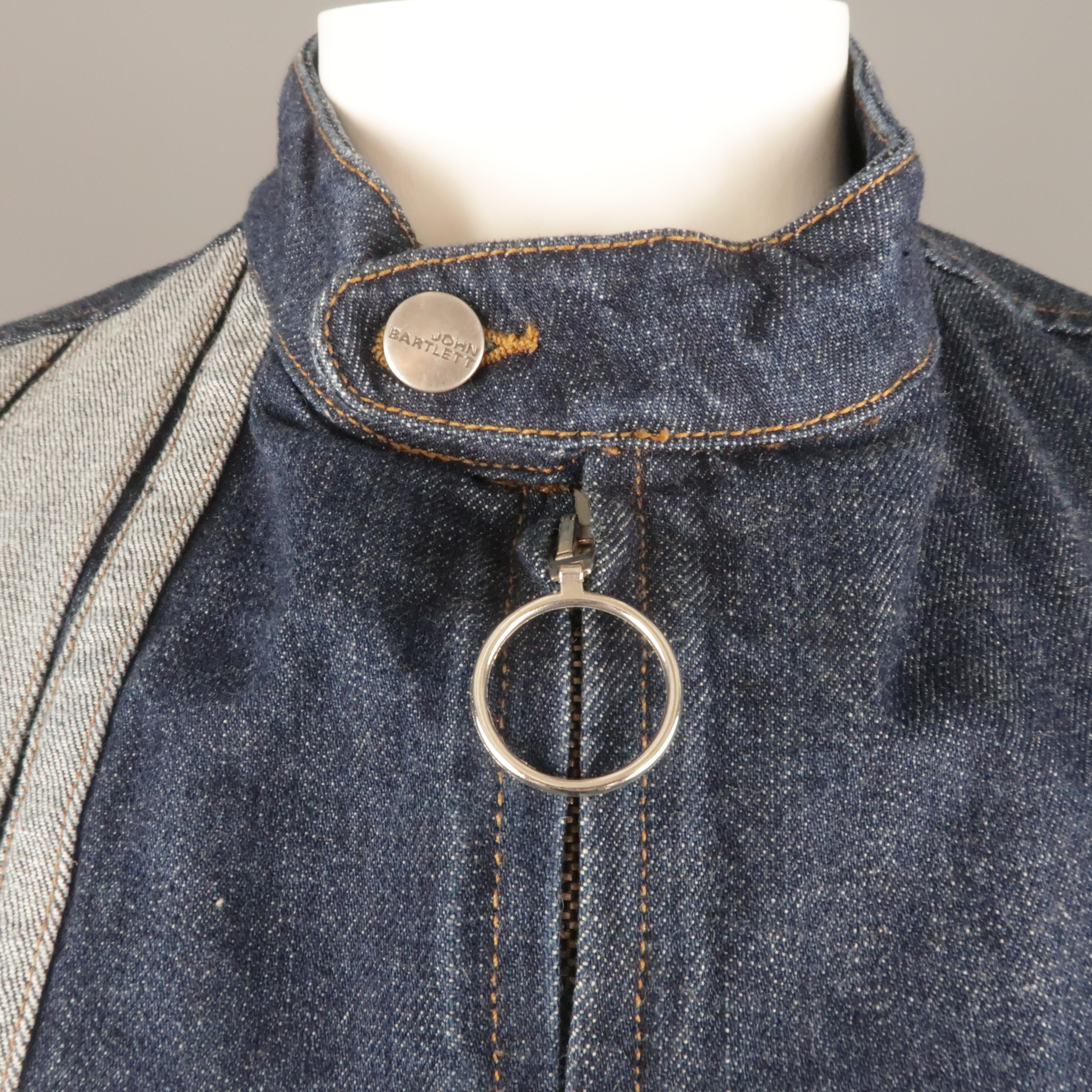 Vintage JOHN BARTLETT biker style jacket comes in classic indigo navy denim with a band button tab collar, zip up front with O tab, patch flap pocket, and reverse denim stripes. Made in Italy.
 
Excellent Pre-Owned Condition.
Marked: IT 52
