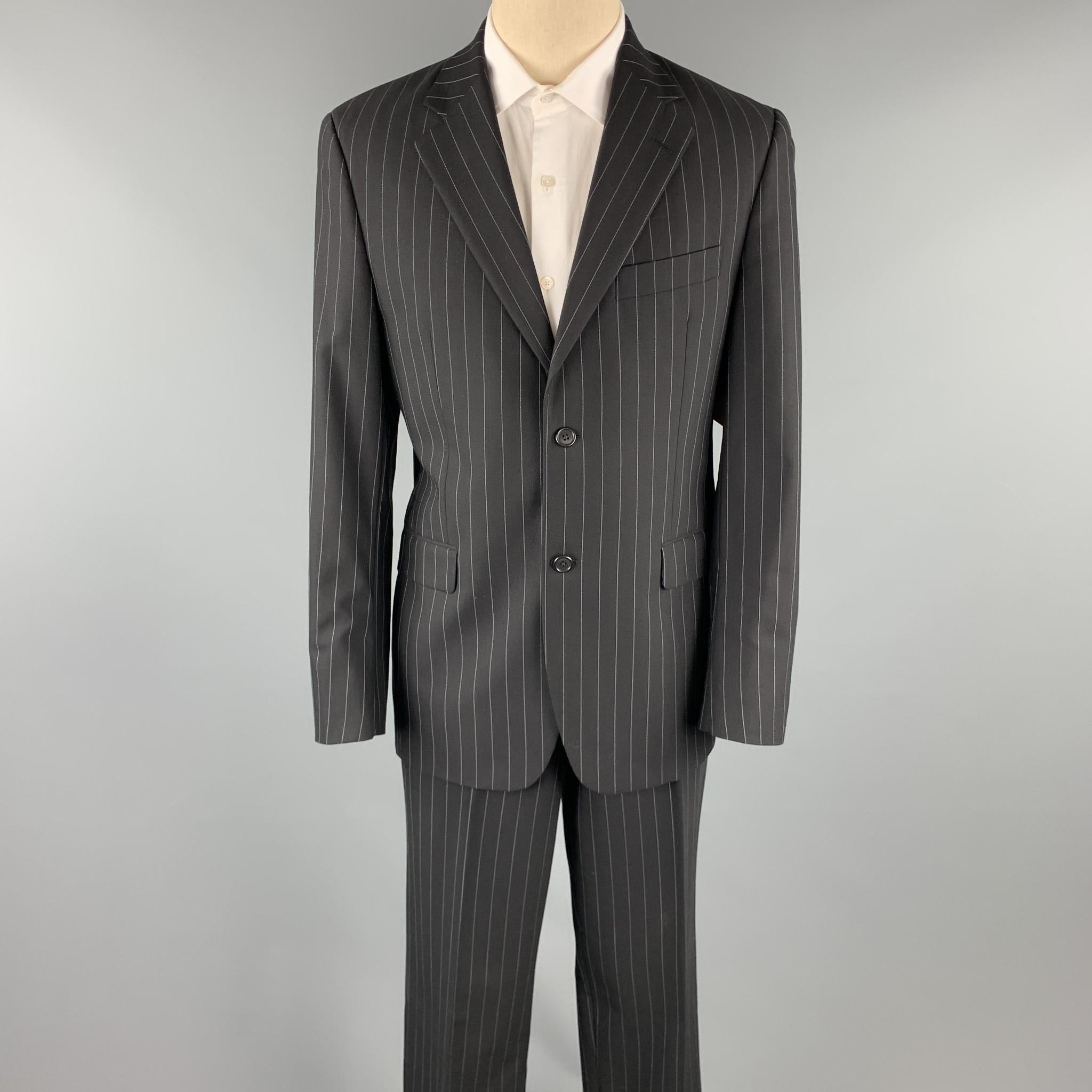 JOHN BARTLETT suit comes in a black chalk stripe wool and includes a single breasted, two button sport coat with a notch lapel and matching flat front trousers. 

Excellent Pre-Owned Condition.
Marked: 40 R

Measurements:

-Jacket
Shoulder: 18 in.