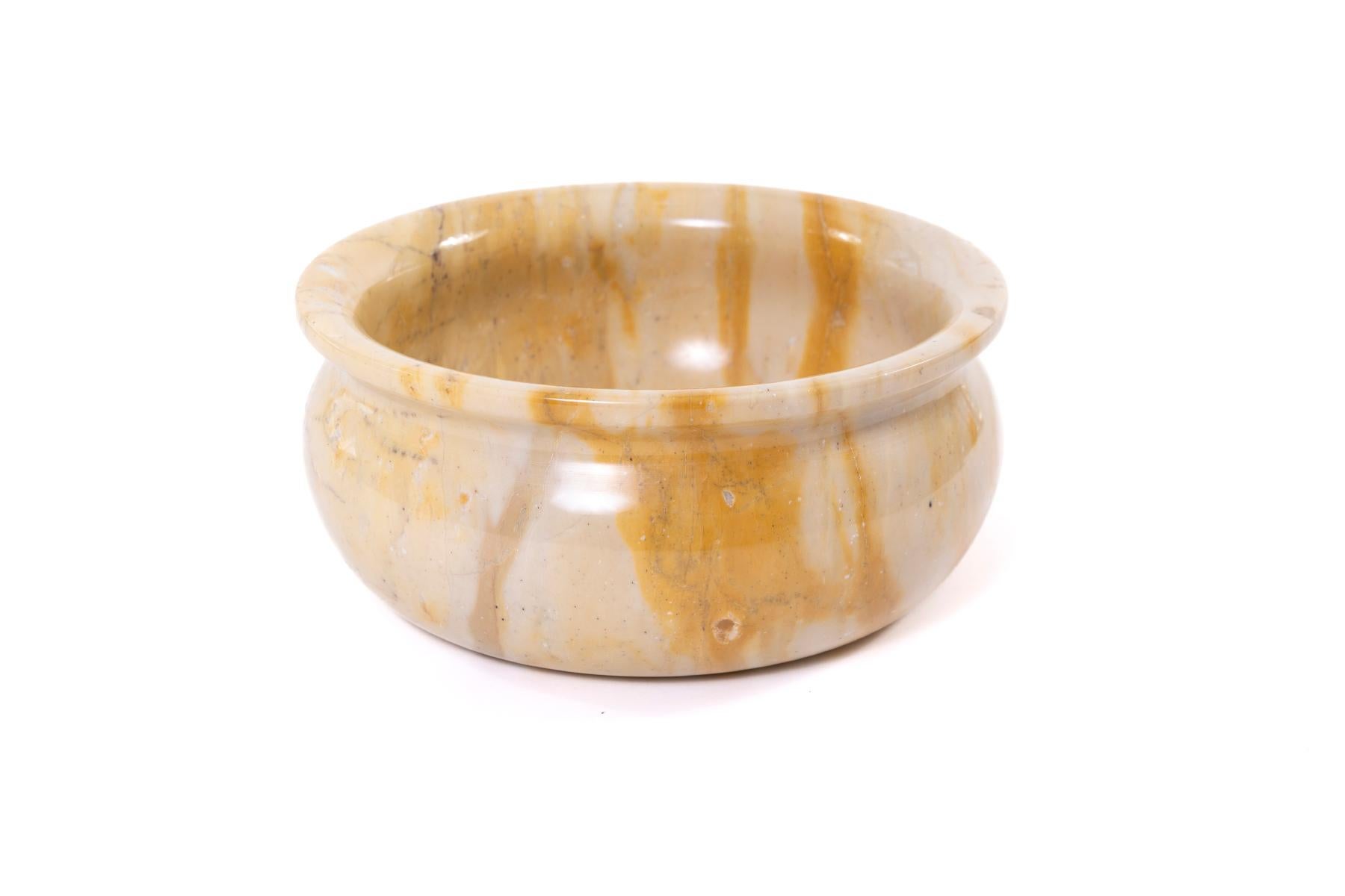 Sleek set of decorative bowls in solid marble by artist John Bartolomeo. A larger yellow bowl measuring 11