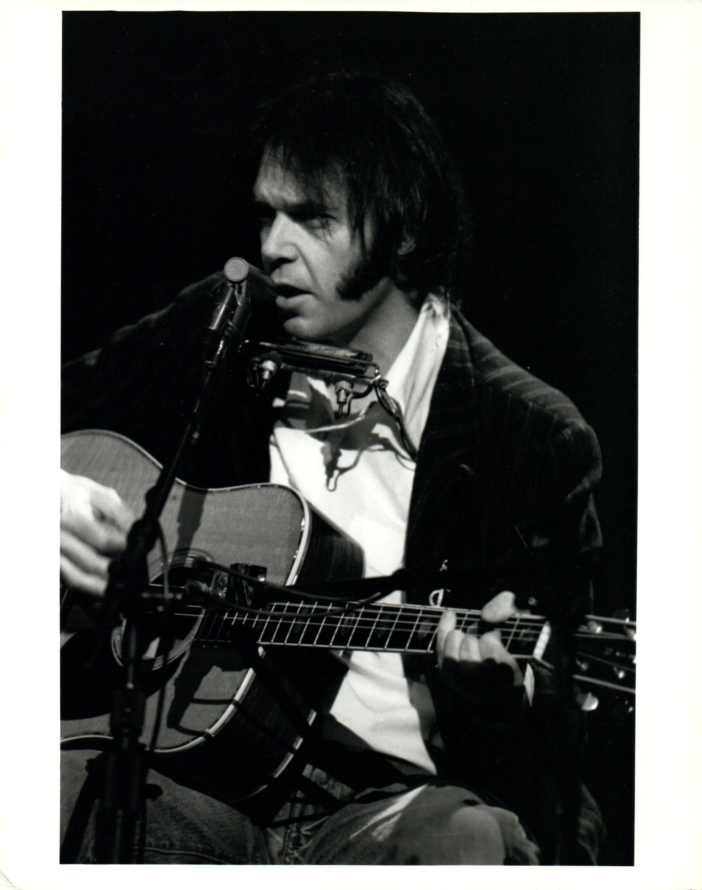 John Bellissimo Portrait Photograph - Neil Young With Guitar and Harmonica Vintage Original Photograph