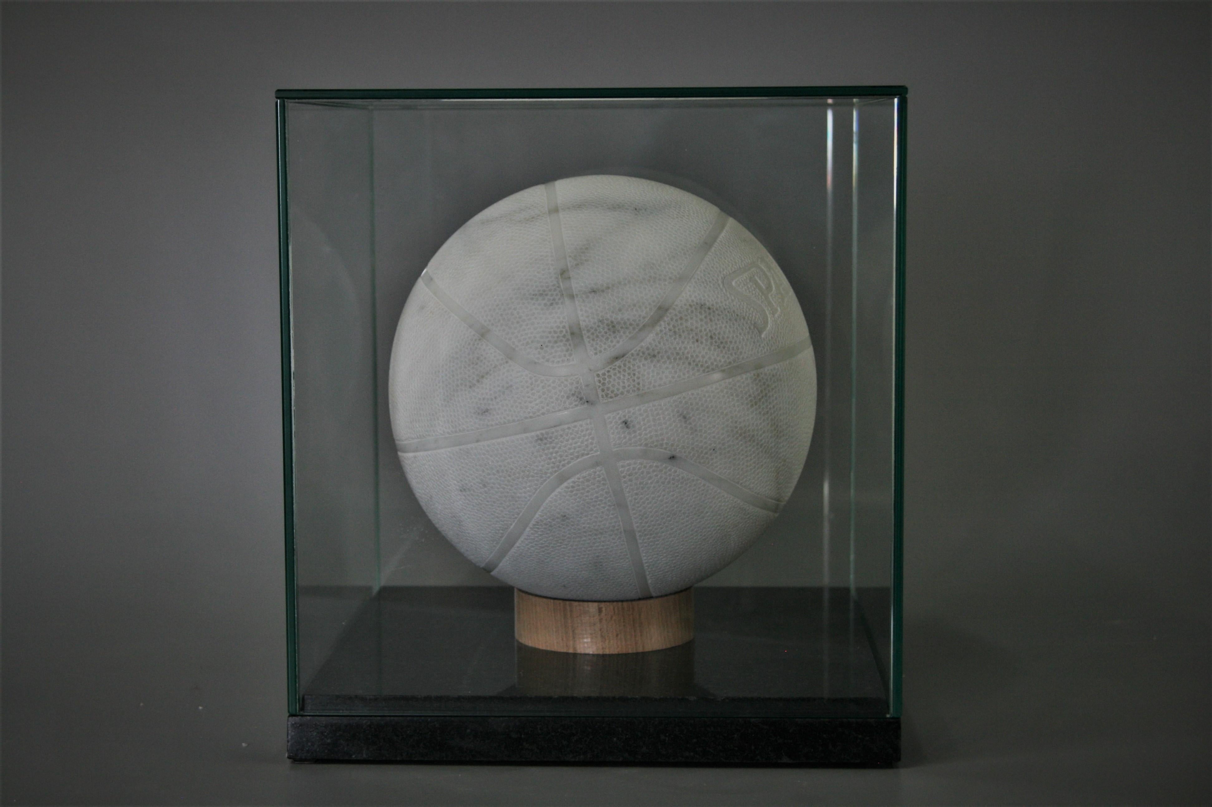 This marble sculpture is hand carved with Carrara Statuario marble! 
The Ball is available either with or without the showcase. Also the bottom of the showcase can be made in any color of stone or wood. The Sculpture and the Showcase are packed in