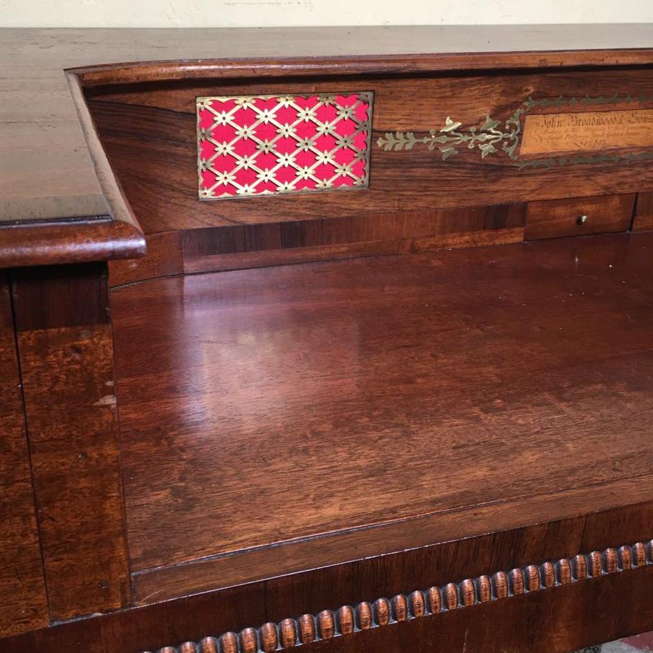 An early 19th century mahogany square piano by John Broadwood and Sons, London converted into a dressing table or desk, dated 1806.

A rounded rectangular desk in mahogany with rosewood crossbanding, ebony line inlay and brass foliate inlay,