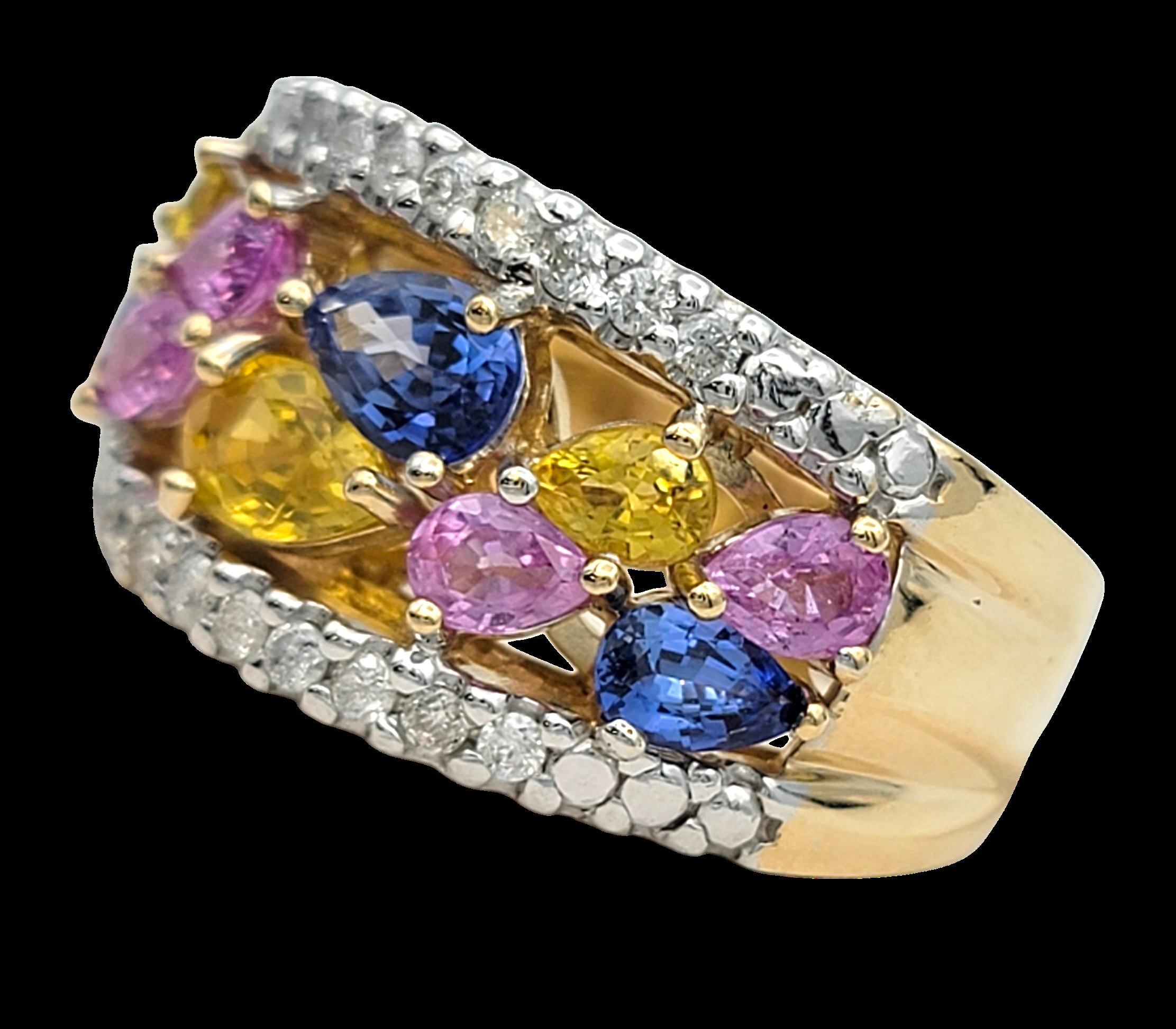This spectacular ring by John C. Rinker features a lively mix of colorful stones set across a wide, eye-catching band. Shades of pink, yellow, and blue create a cheerful blend that feels bright and playful. Each stone has a soft pear shape, giving