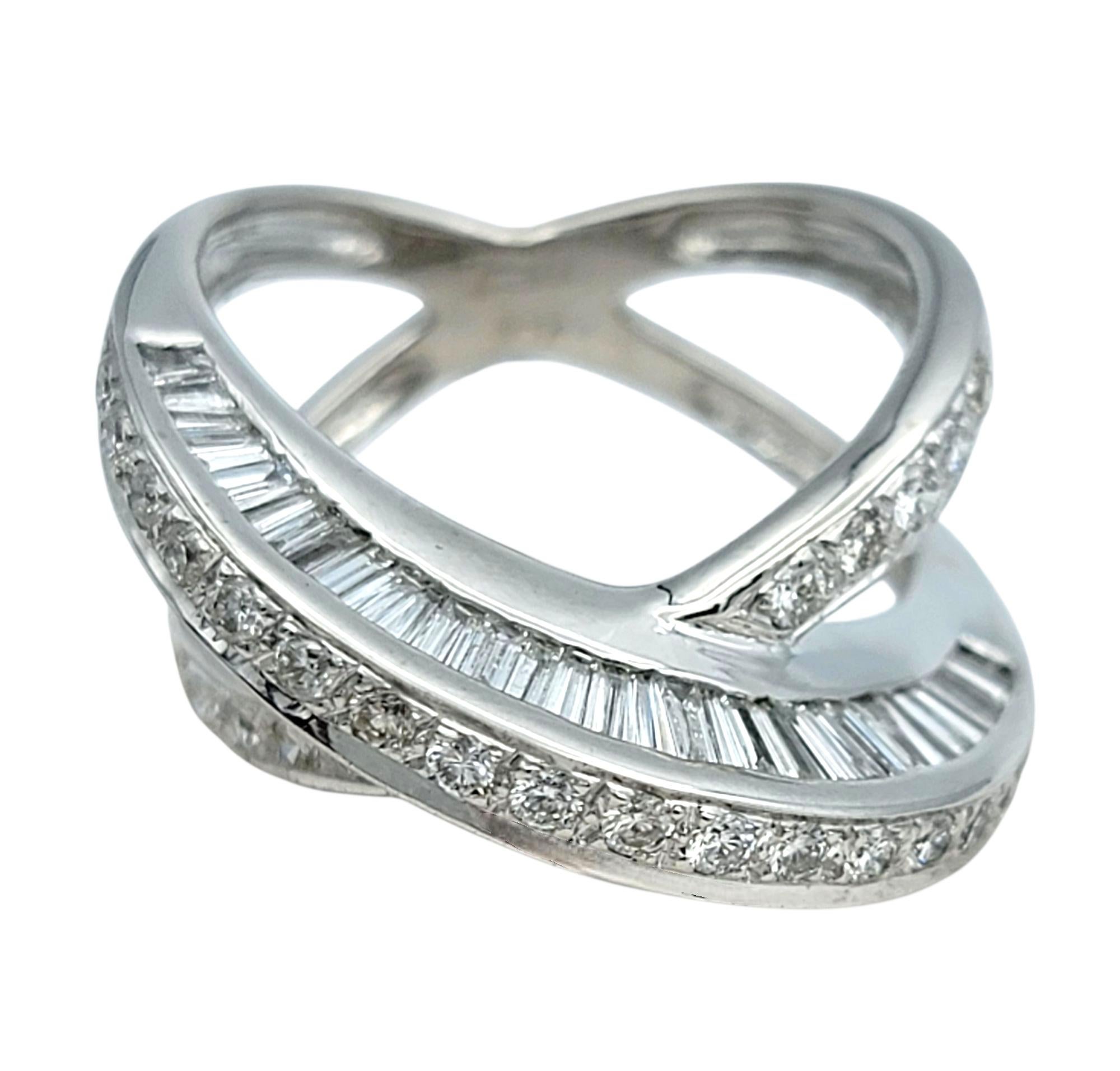 Ring Size: 5

This sleek and stylish ring features a crisscross band of round and baguette-cut diamonds set in a sleek 18 karat white gold setting. The dynamic crossover style gives the ring a sculptural quality, with each diamond channel set for