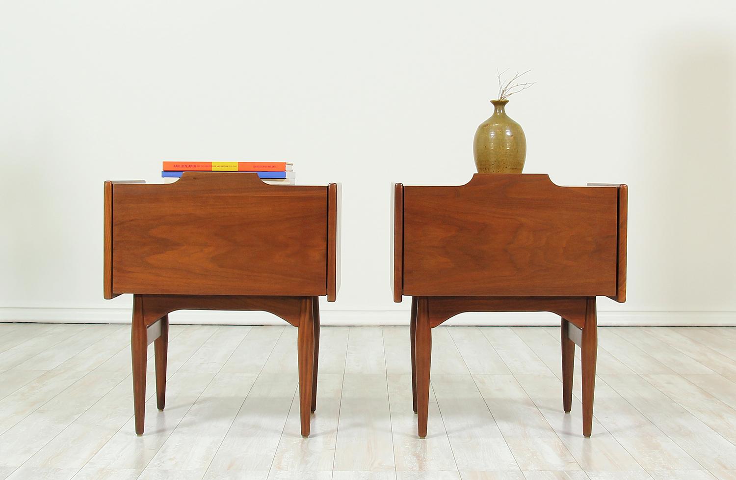 Pair of nightstands designed by John Caldwell for Brown Saltman in the California in 1965. Created as part of the Today line for Brown Saltman, this stunning pair of nightstands are comprised of walnut wood and sit on four tapered legs with a