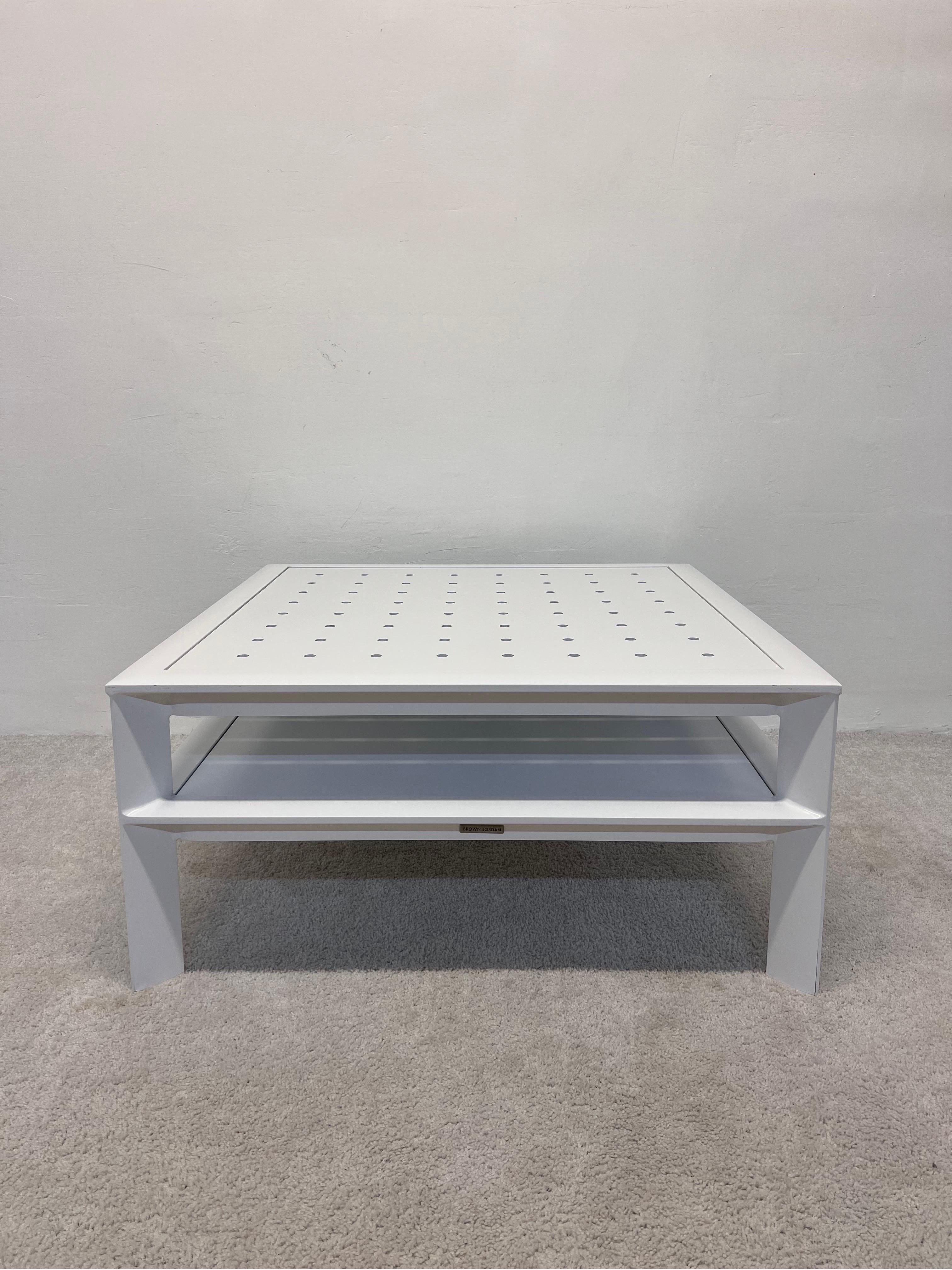White powder-coated aluminum outdoor coffee or cocktail table with perforated top and lower shelf by John Caldwell for Brown Jordan.

We have two tables available.
Ref. # LU5392230980922.