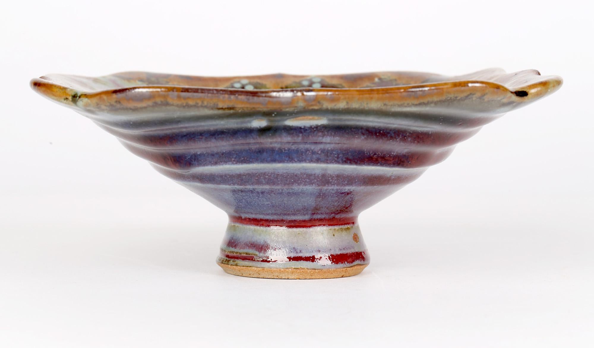 A stylish and well-made studio pottery pedestal dish decorated in multiple glazes by renowned Lancashire based potter John Calver and dating from the 20th or early 21st century.
John has been making stoneware pottery in the North Lancashire village