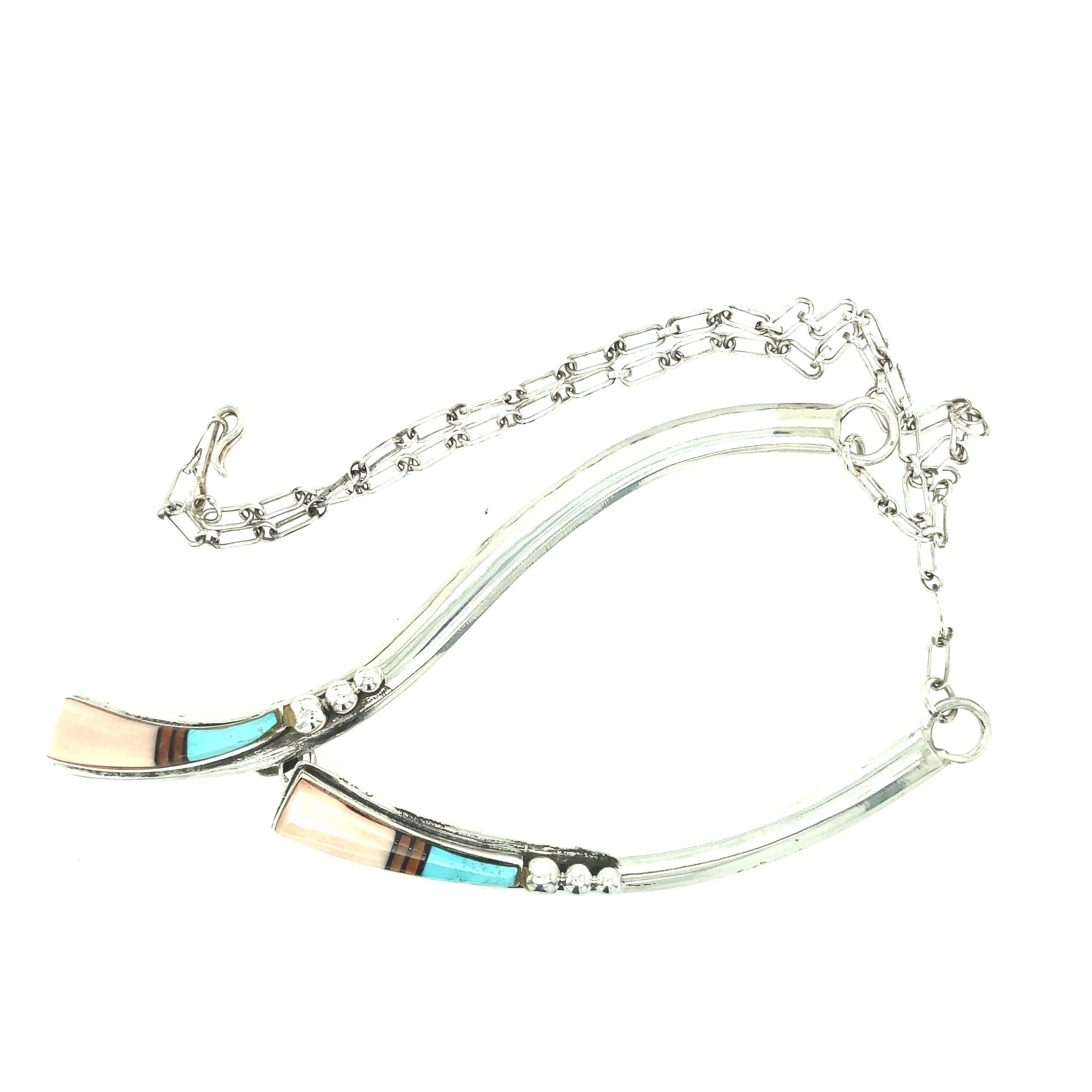 One sterling silver stamped (J. CHARLEY STERLING) John Charley Navajo necklace set with coral and turquoise inlay suspended from a link chain with hook and eye closure.  The necklace measures 19 inches in length.  