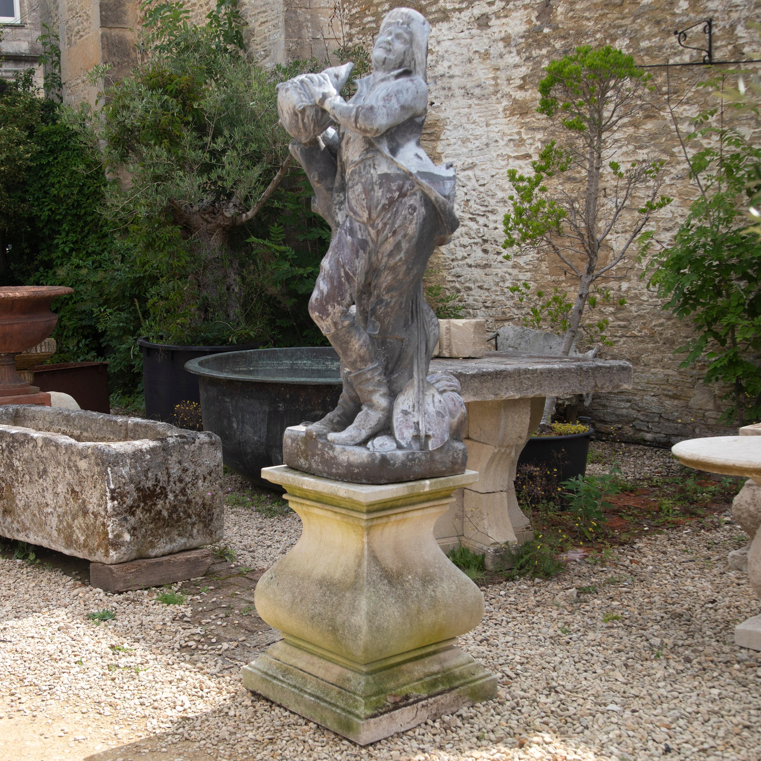 Wonderful English 18th century lead garden figure. 

This statue depicts a jovial musician with his instrument. Resting on a shaped pedestal base. 

This charming figure comes from the workshop of John Cheere, which was established at Hyde Park