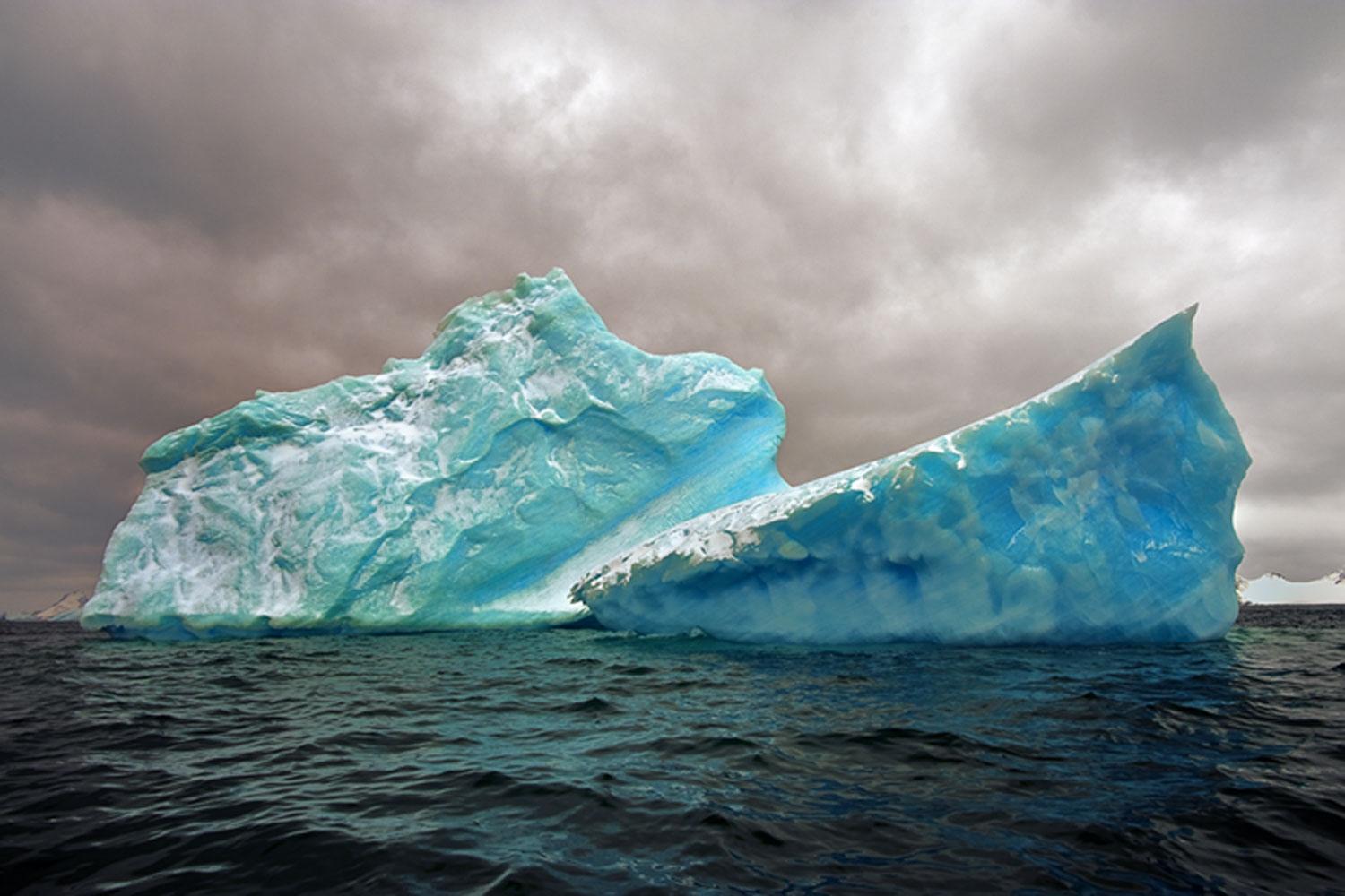 Antarctica #98 is a limited edition photograph taken by John Conn in 2010.  It is a 20x30 image, printed on 24x36 archival paper and framed in a white frame.  It features two Icebergs.   It was printed in 2019.

John Conn got his start as a Marine
