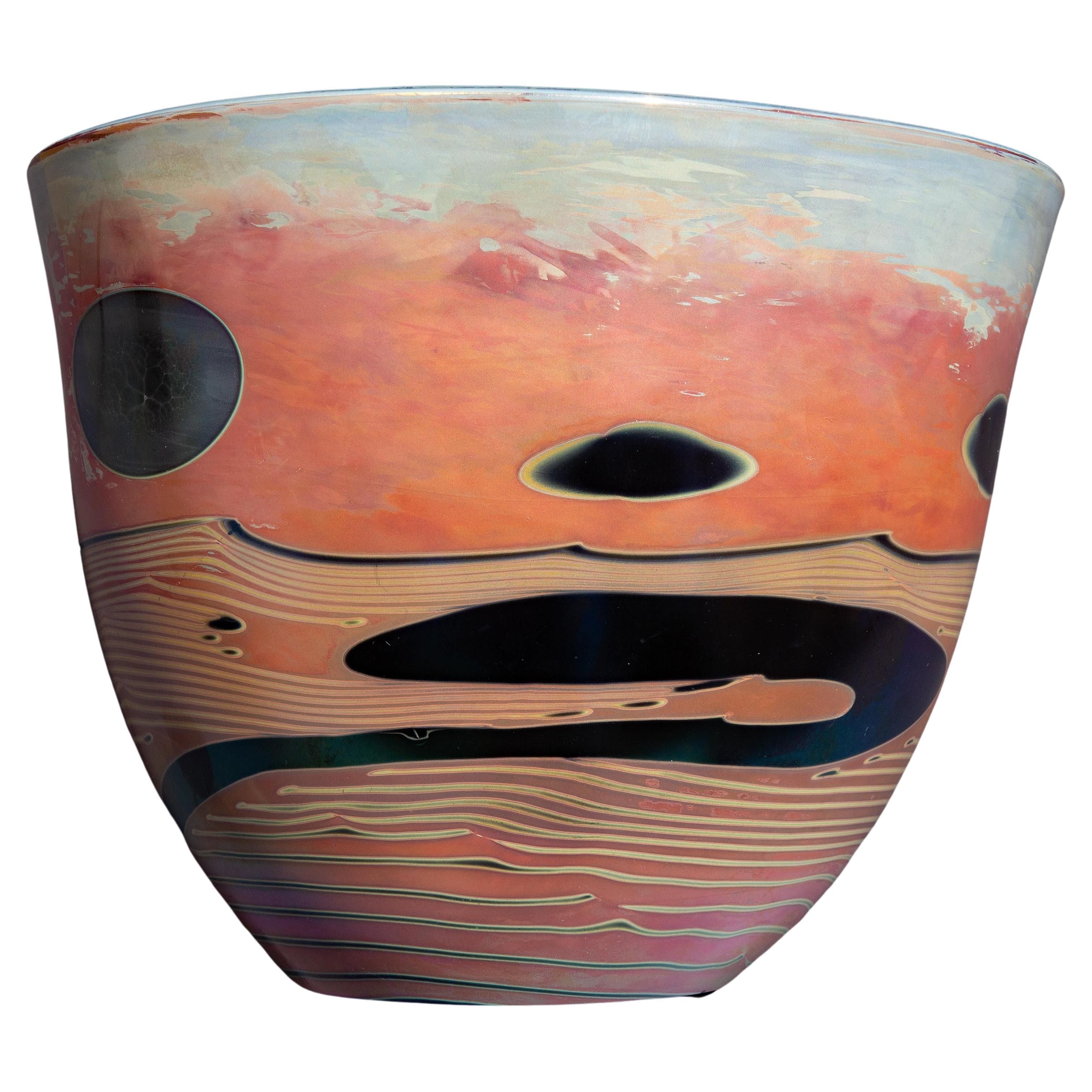 John Conrad Lewis (American, b. 1942) Moon Bowl
1979, from the Moon Bottle series. Hand-blown glass with abstract landscape of red, pink, and blue iridescent art glass . Inscribed 'Lewis 79 217'.  Note: This is was the 217th piece done by Lewis in