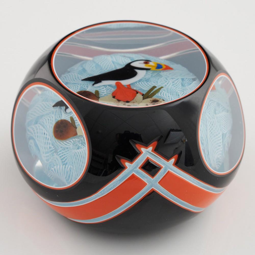 Heading : A John Deacons Triple Overlay Puffin Paperweight 2006
Date : 2006
Origin : Scotland
Features : Lampwork Puffin on the rocks on a muslin ground all with triple colour, whoute orange and black, cut paperweight
Marks : A JD 2006 cane to the
