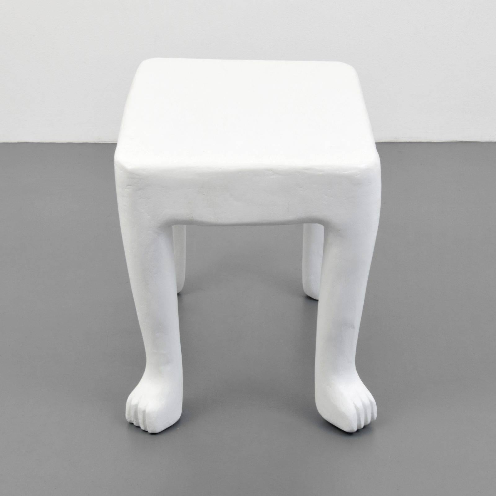 A beautifully preserved plaster “African” end-table by John Dickinson.  One of his most popular and recognizable designs, Dickinson produced these tables from 1976 to 1980. These monochromatic pieces were constructed from a plaster-like high