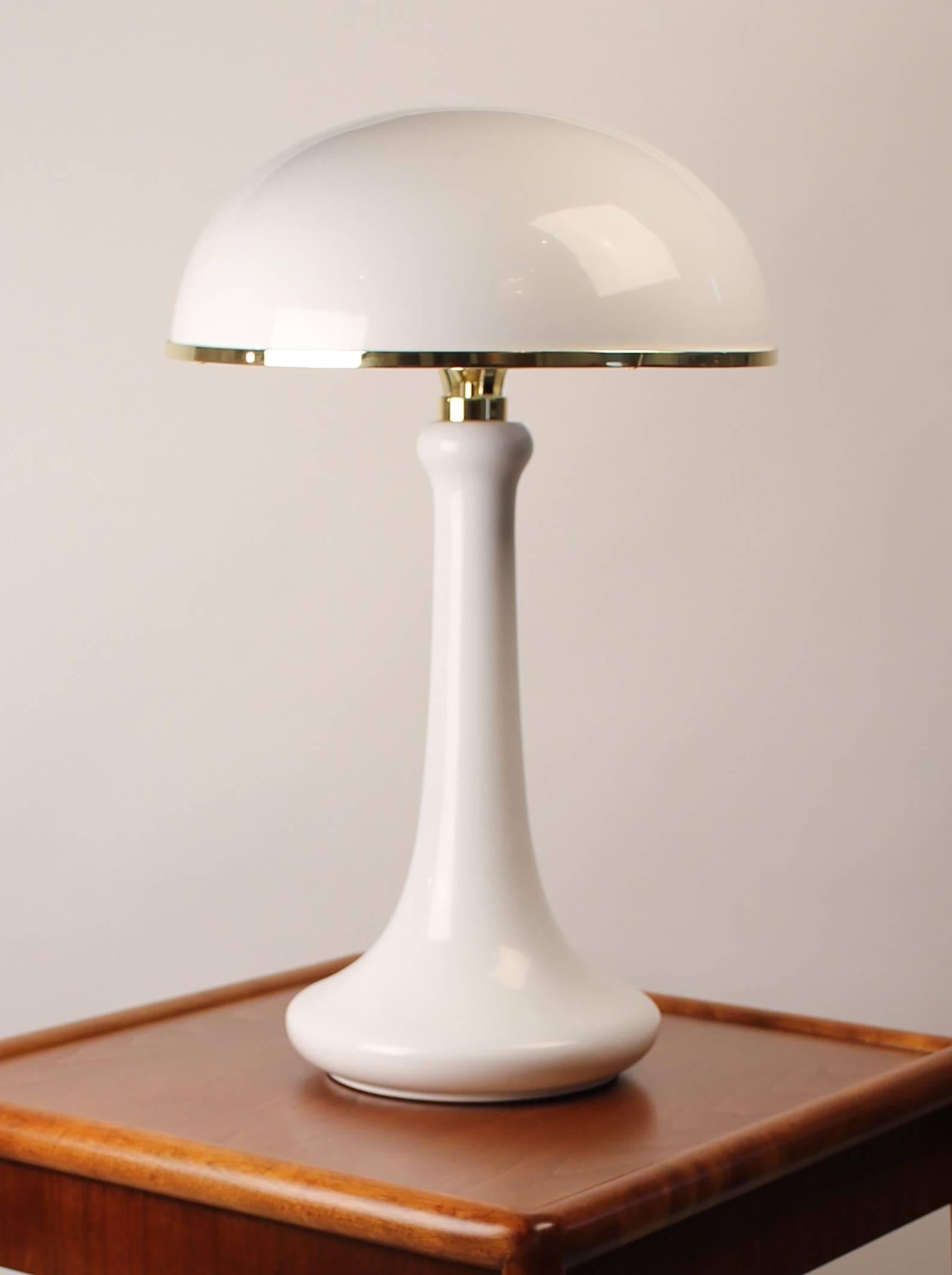 Later production John Dickinson table lamp with lacquered dome shade and brass embellishments. UL listed. Licensed Edition from the 1975 design. Excellent condition. Works with a 50-150 watt bulb.