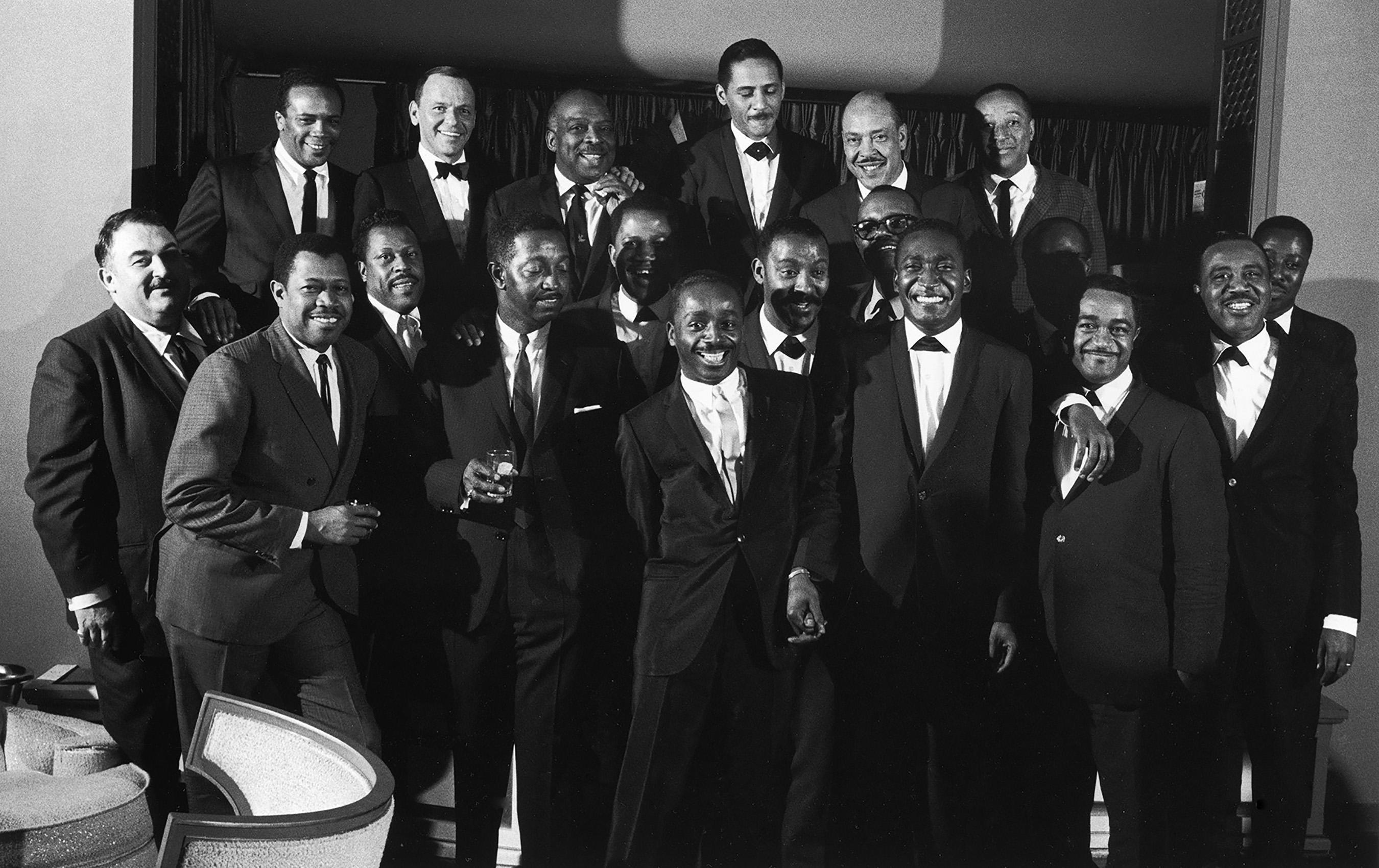 John Dominis Black and White Photograph - Frank Sinatra posing with Count Basie and his band, Las Vegas, 1964