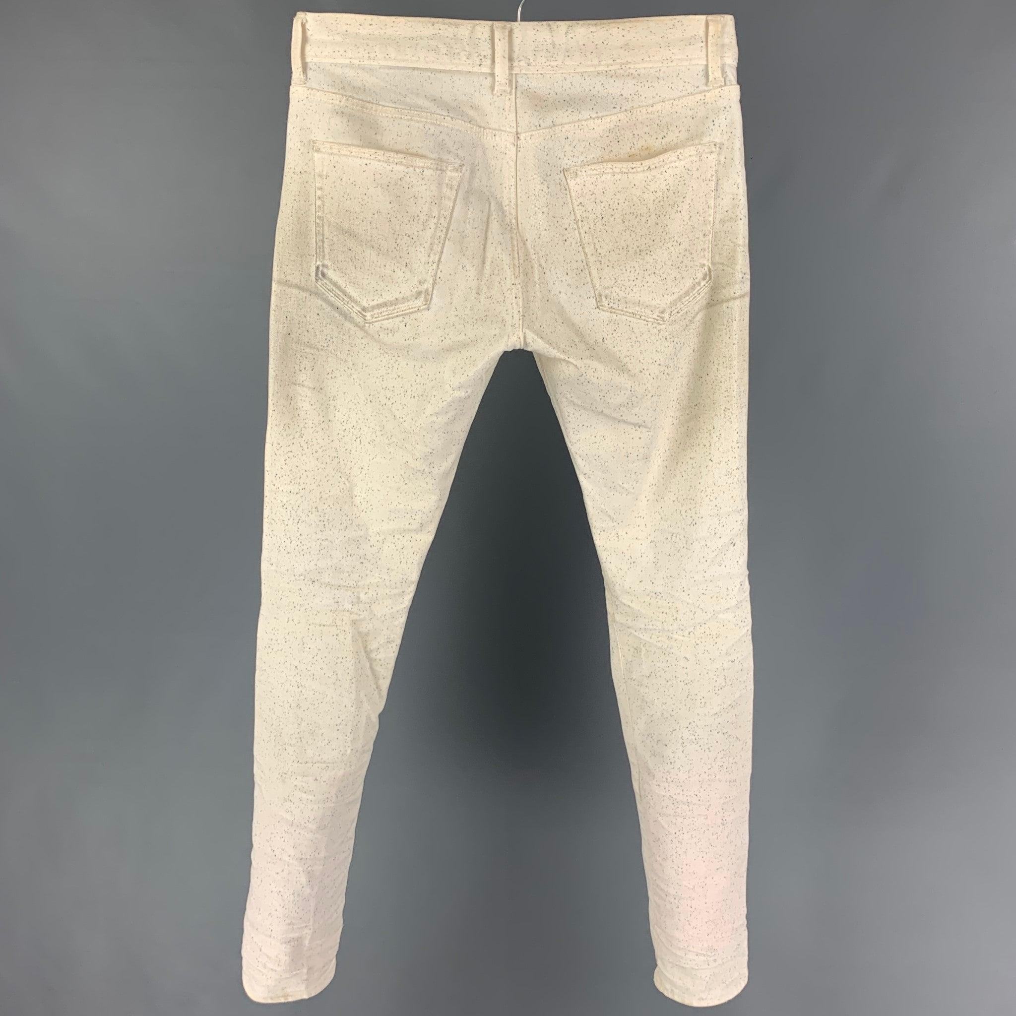 JOHN ELLIOTT 'Season Nine' jeans comes in a off white & black paint splatter cotton featuring a skinny fit, distressed details, and a button fly closure. Made in Japan. Good
Pre-Owned Condition. 

Marked:   30 

Measurements: 
  Waist: 32 inches 