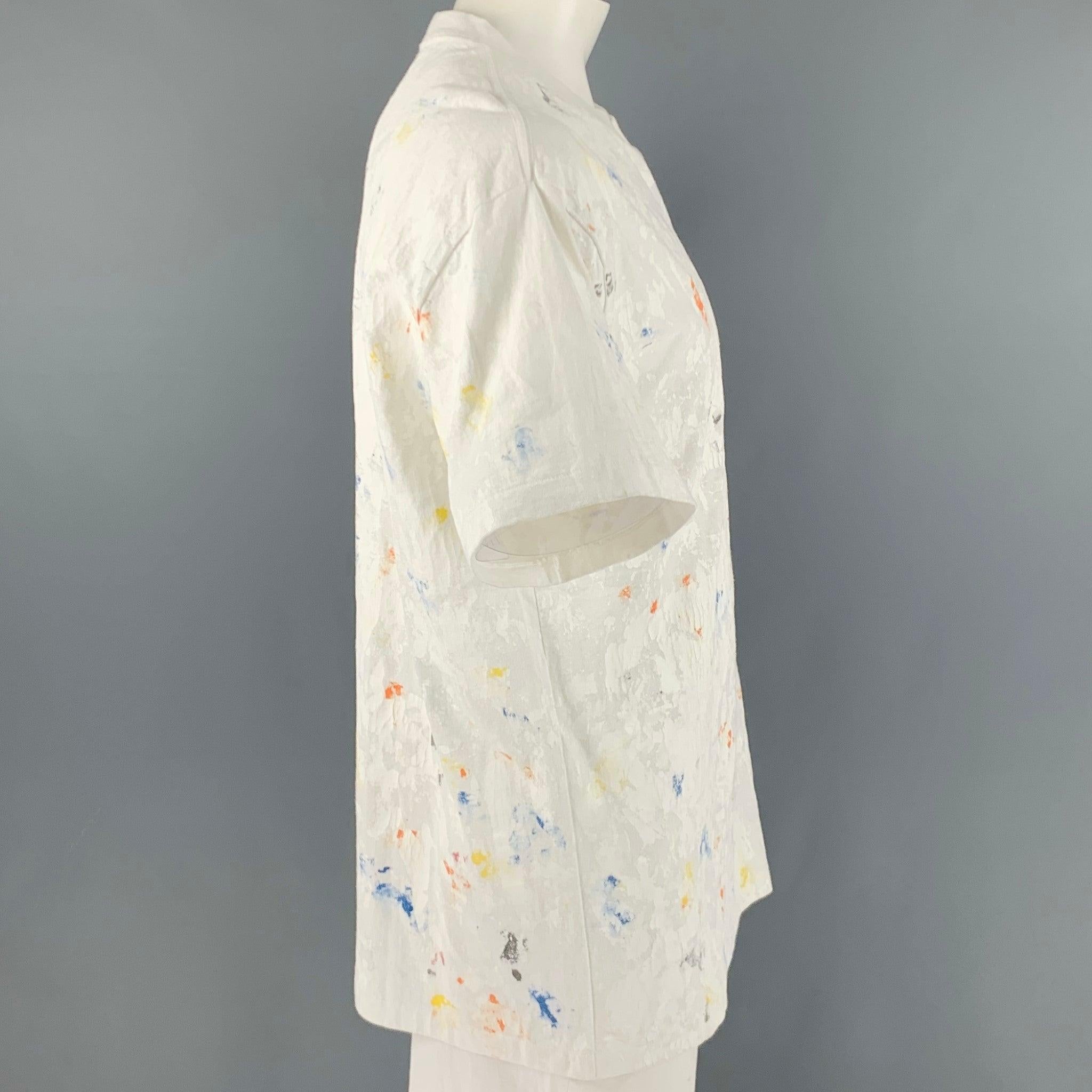 JOHN ELLIOT t-shirt
in a
white cotton fabric featuring a multi-color paint splatter style, and crew neck. Made in Japan.Excellent Pre-Owned Condition. 

Marked:   3 

Measurements: 
 
Shoulder: 22 inches Chest: 43 inches Sleeve: 8.5 inches Length: