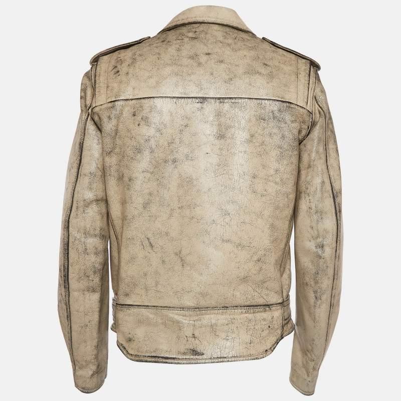 The John Elliott X Blackmeans riders jacket features a unique distressed design with ivory paint accents. Crafted from premium leather this jacket blends rugged style with artisanal craftsmanship. The beige color provides a versatile base while the
