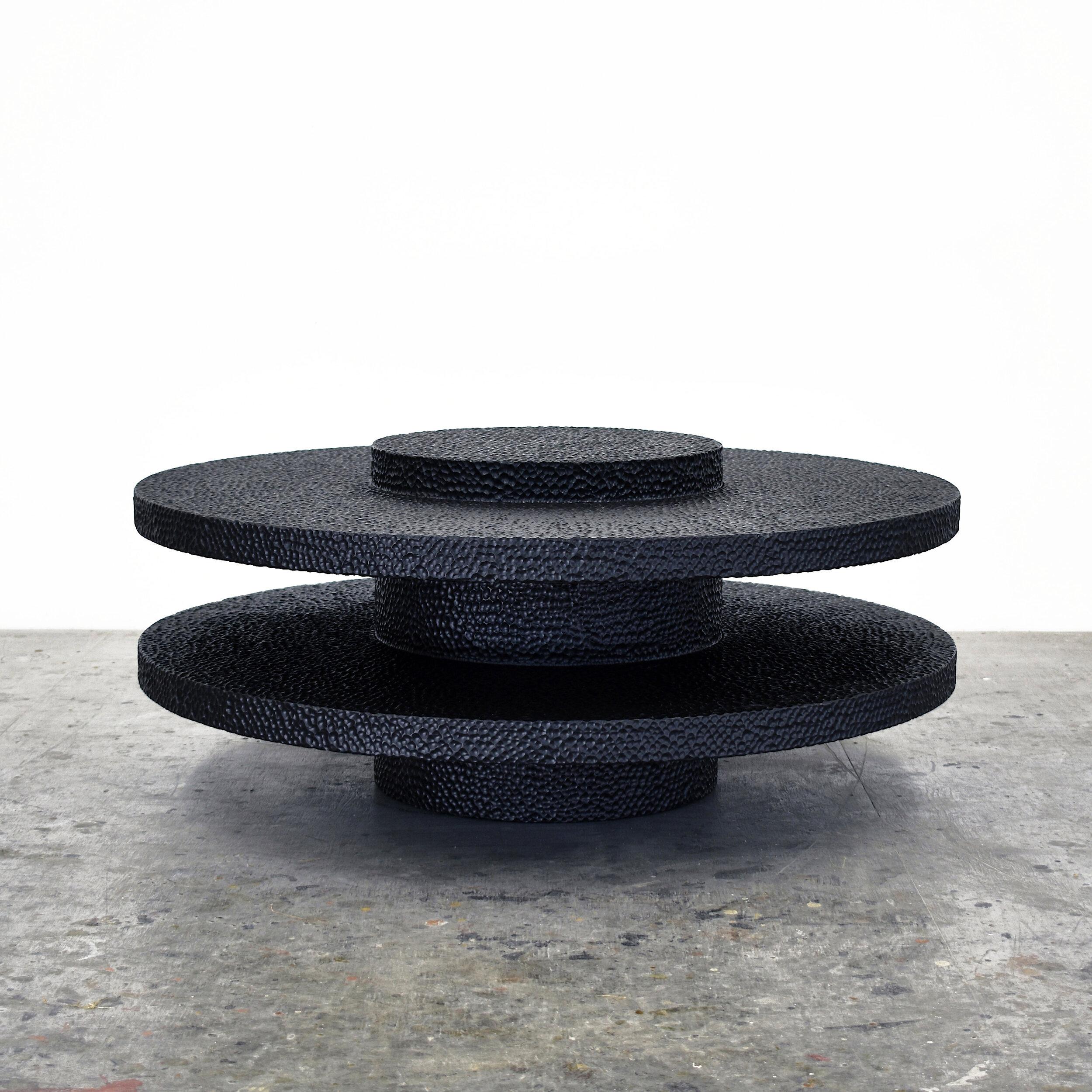 This solid maple table from John Eric Byers merges modern, simplified geometries with traditional craft. The series of stacked circles is painstakingly hand-carved and lacquered with a distinctive textured pattern to give a maximalist finish to a