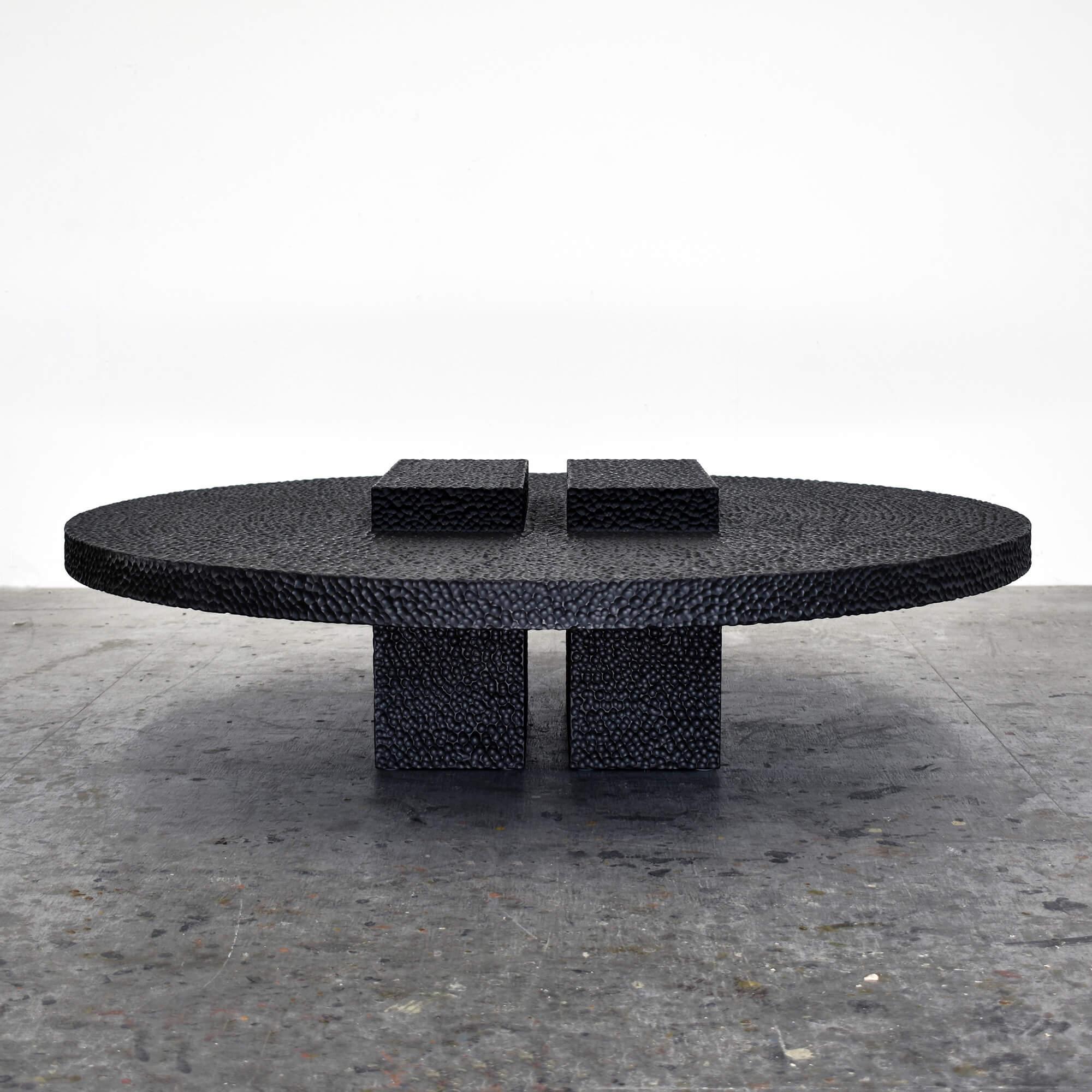 This solid maple table from John Eric Byers merges modern, simplified geometries with traditional craft, painstakingly hand carved and lacquered with a distinctive textured pattern to give a maximalist finish to a minimalist silhouette.

John Eric