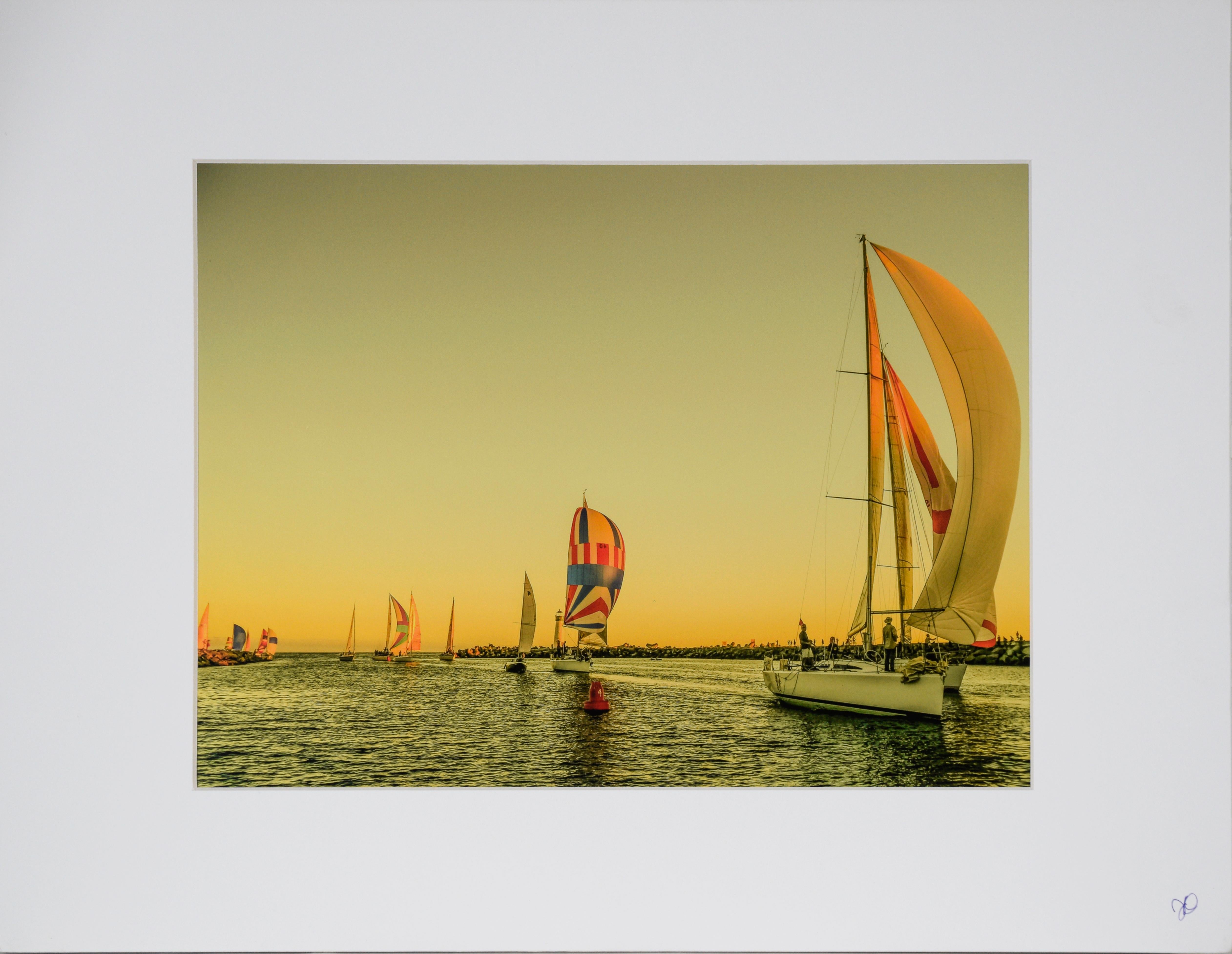 Boats Sailing At Sunset, Santa Cruz - Color Photograph

Color photograph of sailboats at sunset in front of the Breakwater Lighthouse in Santa Cruz, California by John F. Hunter (American). The viewer looks out towards the ocean as multiple colorful