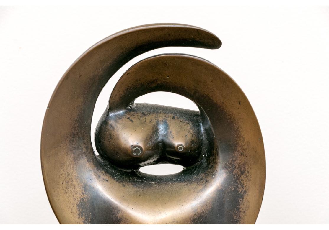 Abstract bronze figure mounted on an oval wood plinth.
Signed back bottom and marked 1/7 
Dimensions: 5