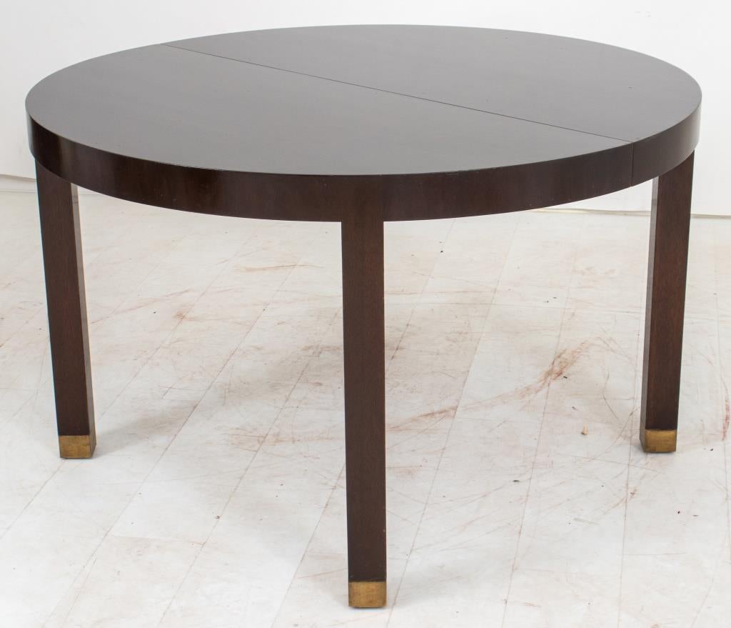 John Fischer Art Deco Revival circular extending wooden dining table with square legs terminating in metal sabots with two leaves. Provenance: Property from a Thad Hayes designed apartment featured in Architectural Digest, February, 2000.

Dealer: