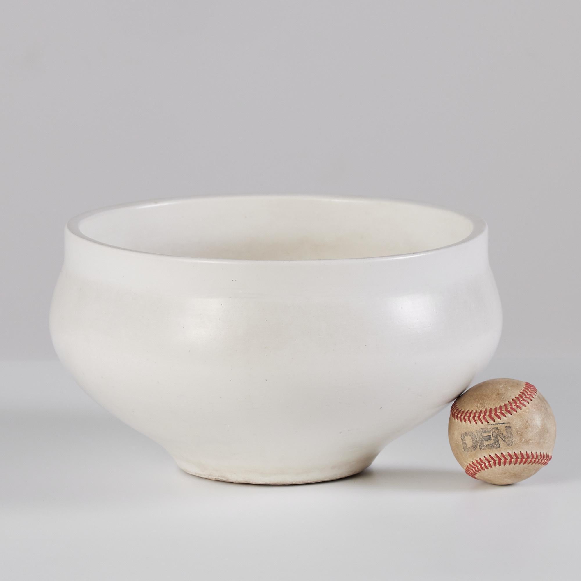 White planter by John Follis for Architectural Pottery. This example has a flat lipped rim and wide belly that tappers towards the bottom.

Dimensions: 11.25