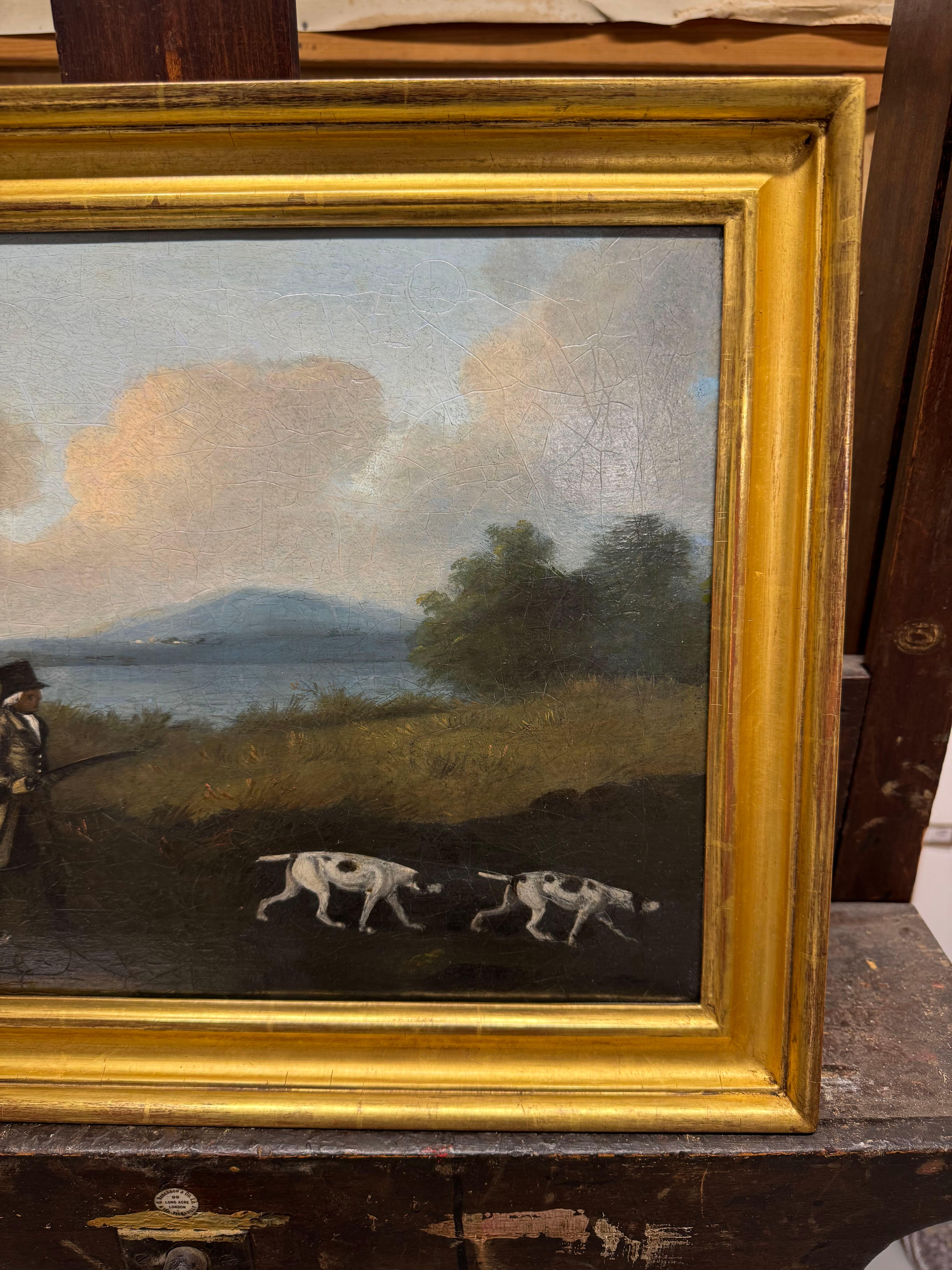 A Gentleman shooting in a landscape with a horse and spaniels 1